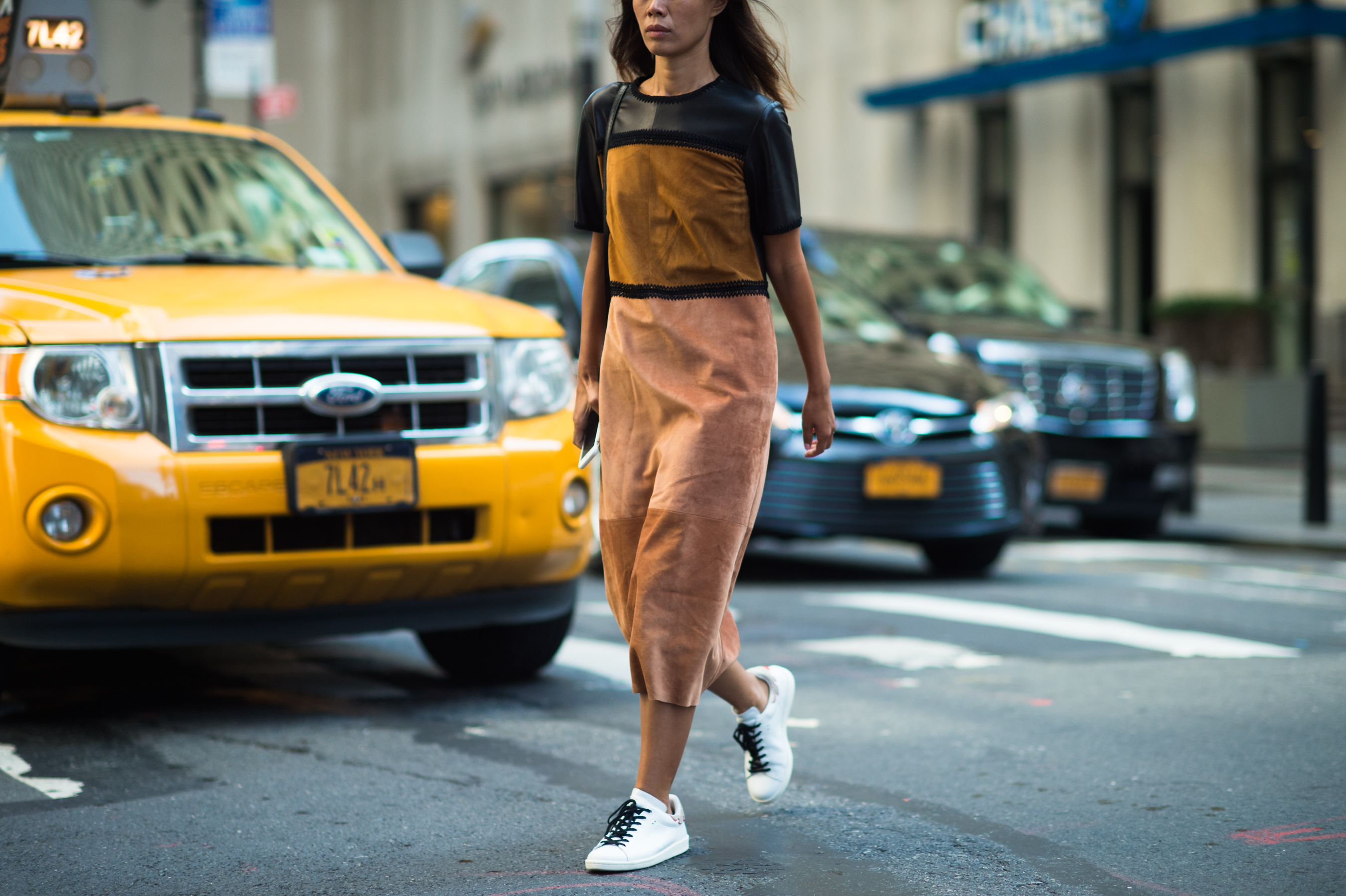 Woman in suede dress crossing the street