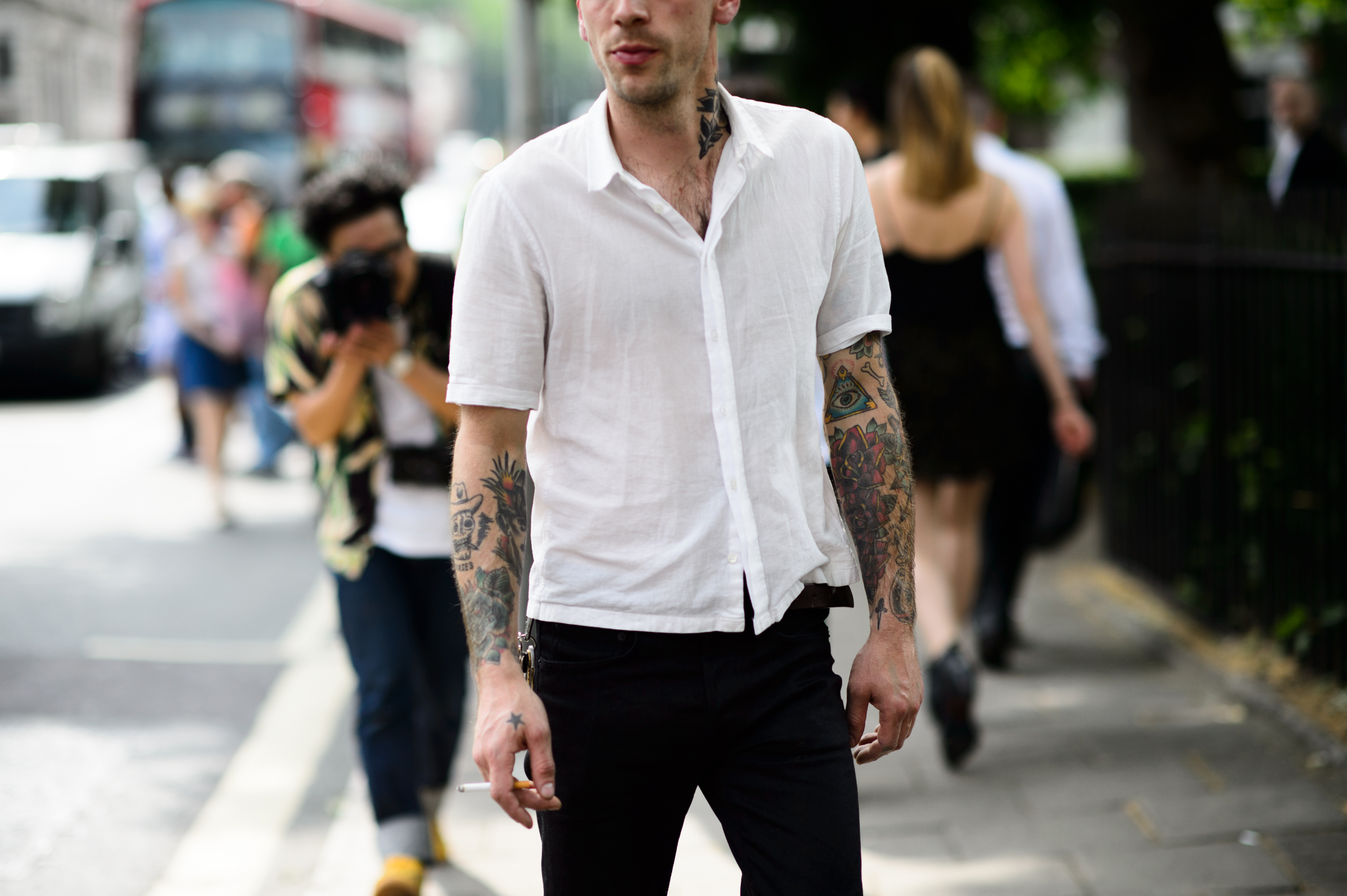 Man with tattoos wearing white shirt