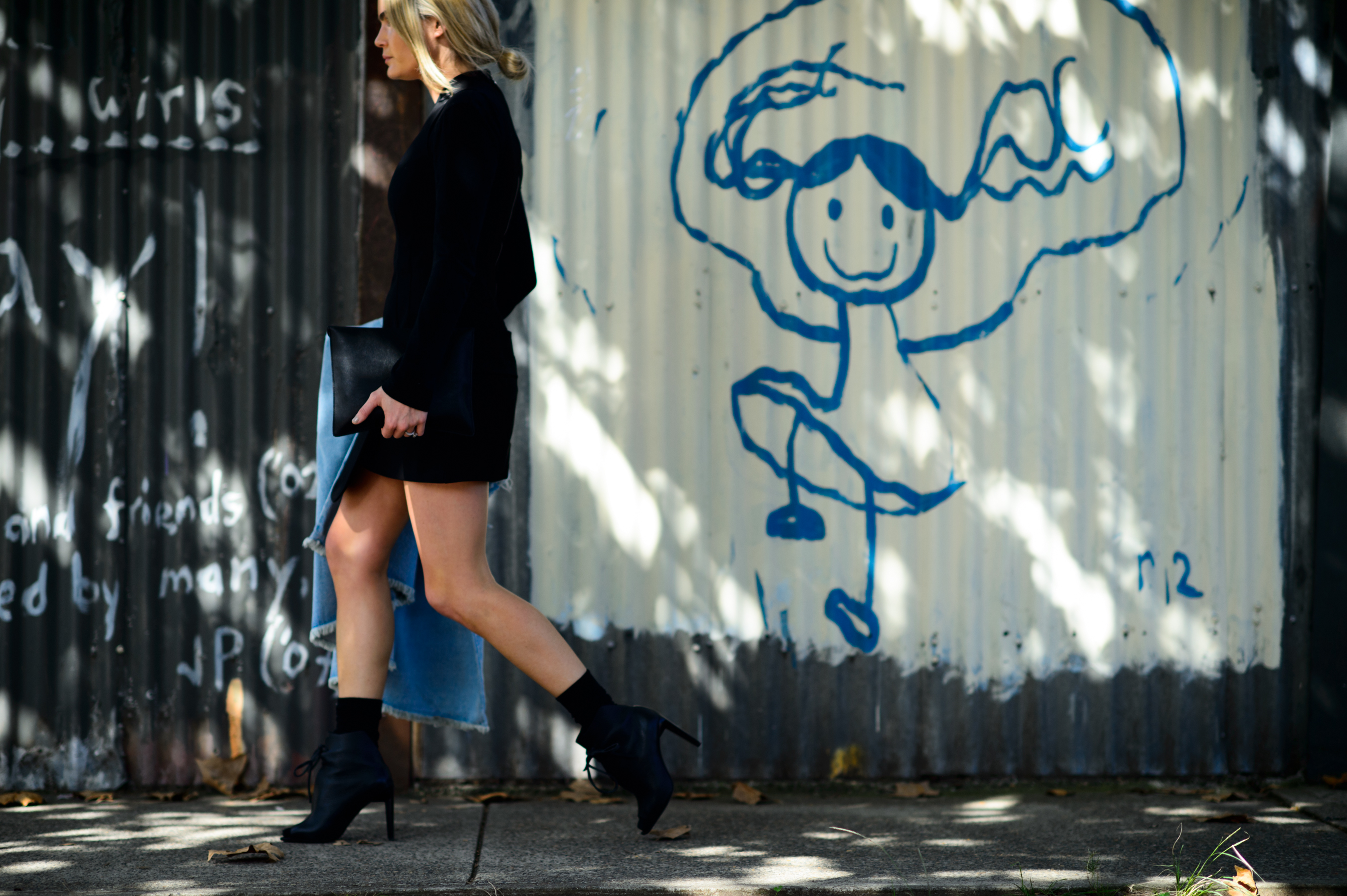 Woman in short black dress and boots
