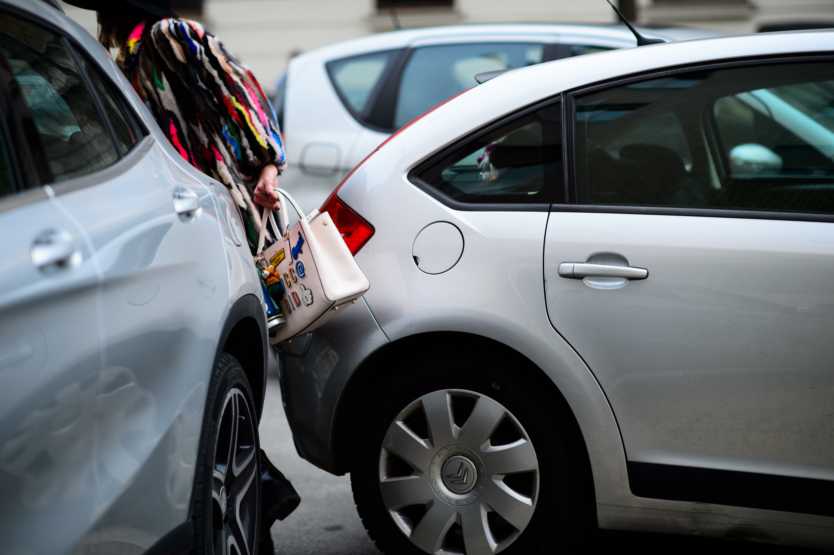 Woman passing through the cars
