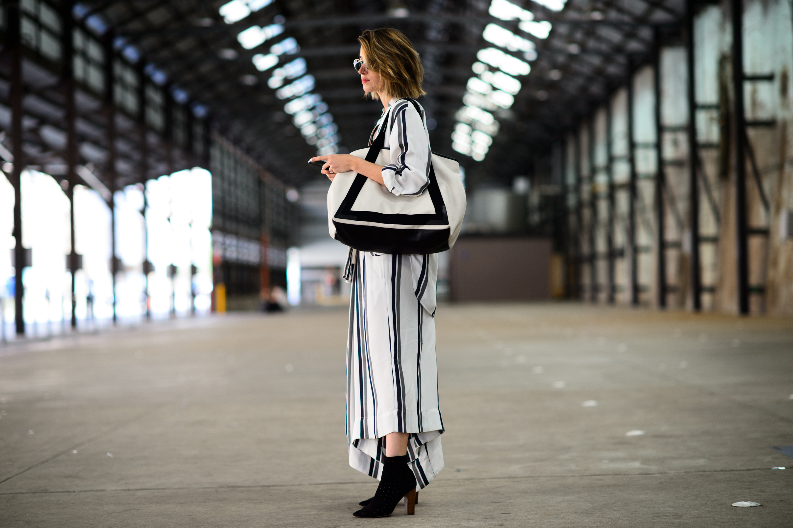 Woman wearing long white cotton dress with wide stripes