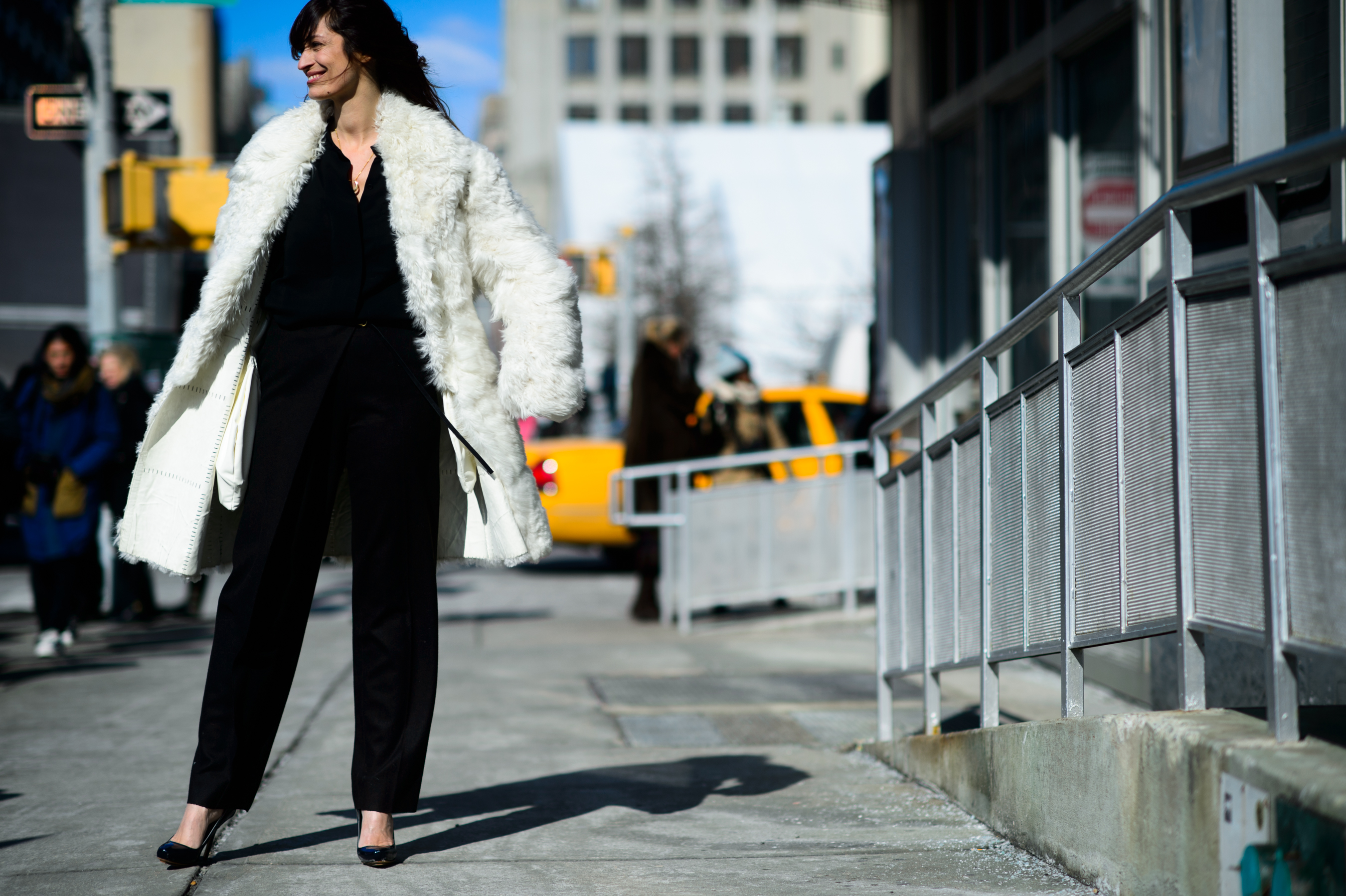 French woman wearing white fur coat before Calvin Klein