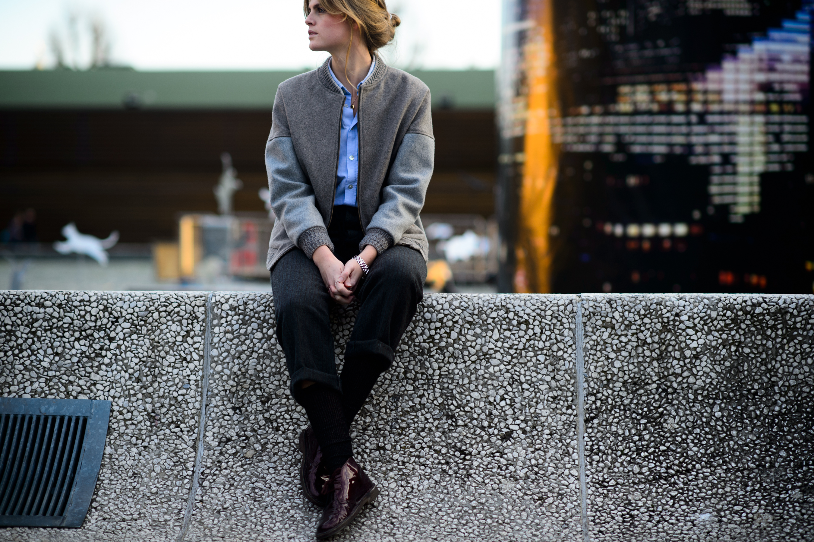 Woman sitting at the Pitti Uomo venue