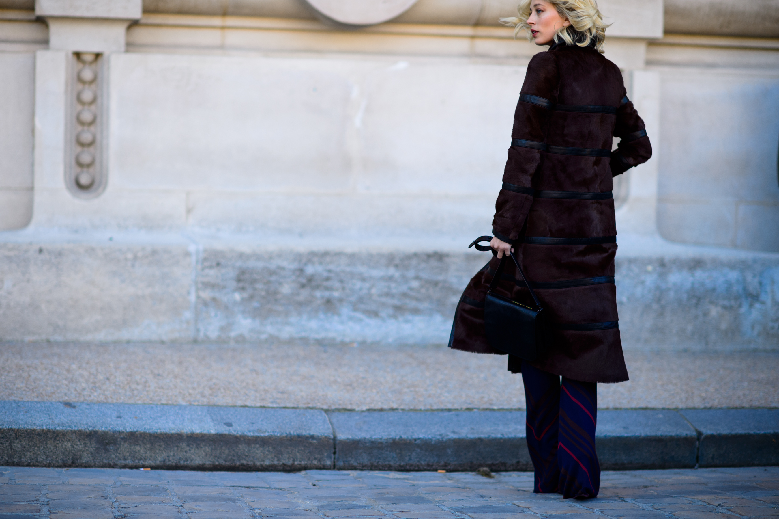 Woman wearing brown coat after the show