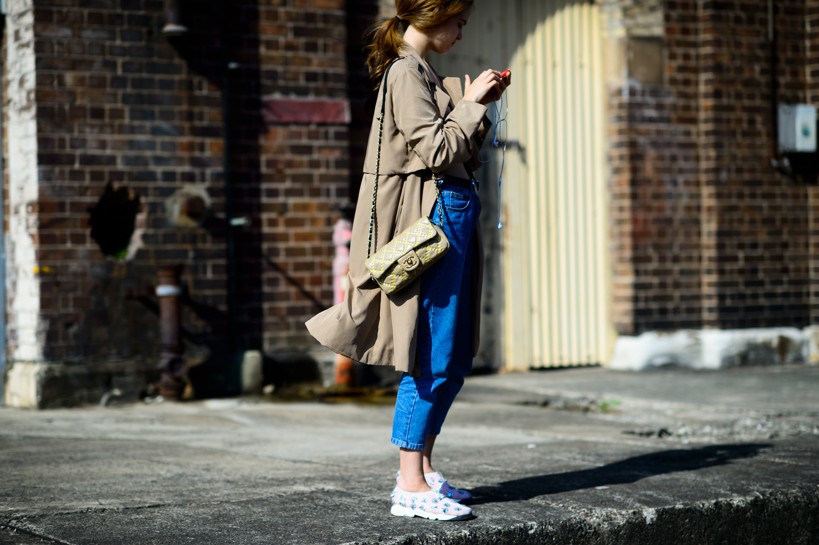 Girl in beige coat and Fusion sneakers