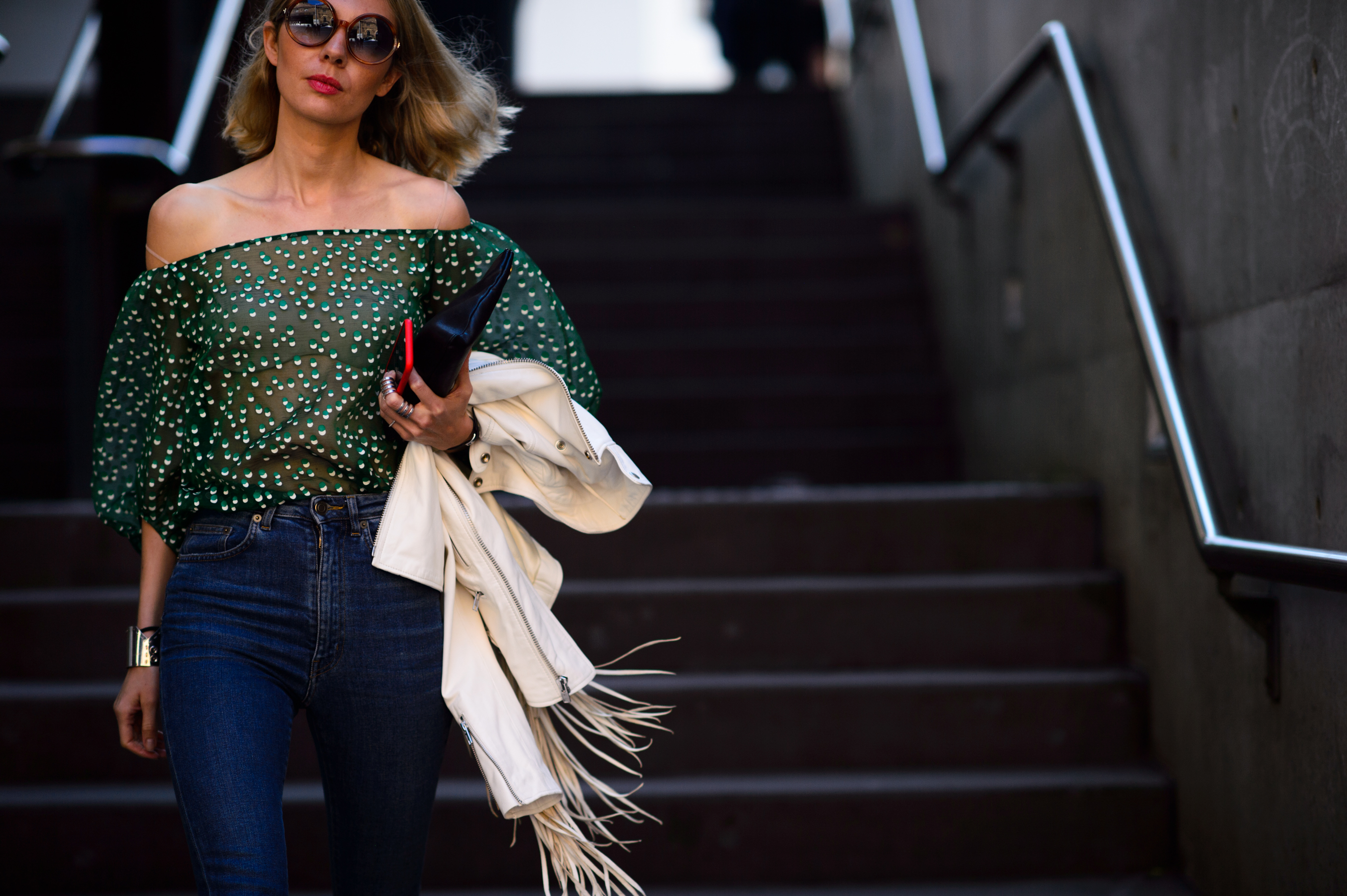 Woman wearing sheer green top and denim
