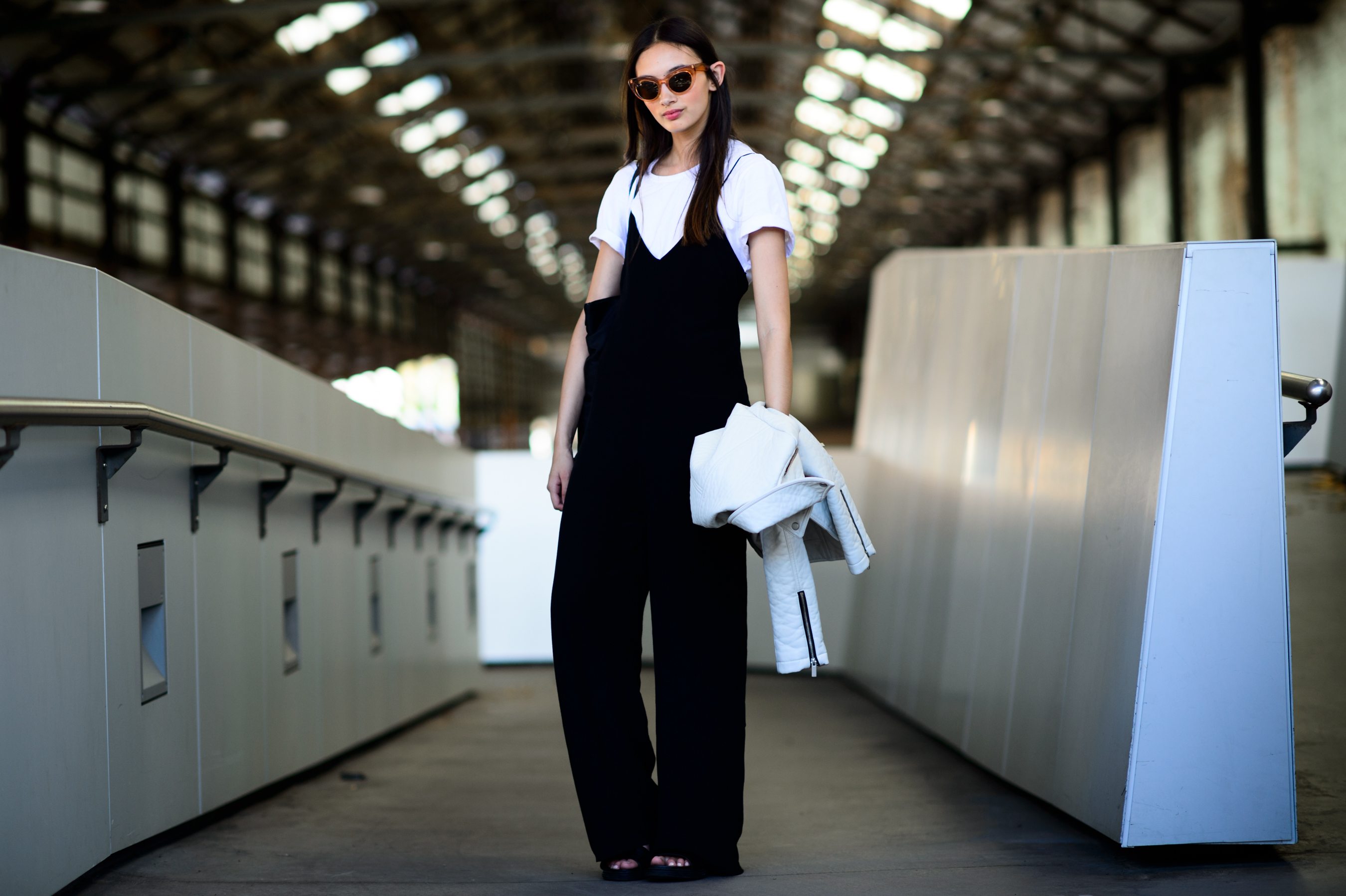 Model in black jumpsuit and glasses