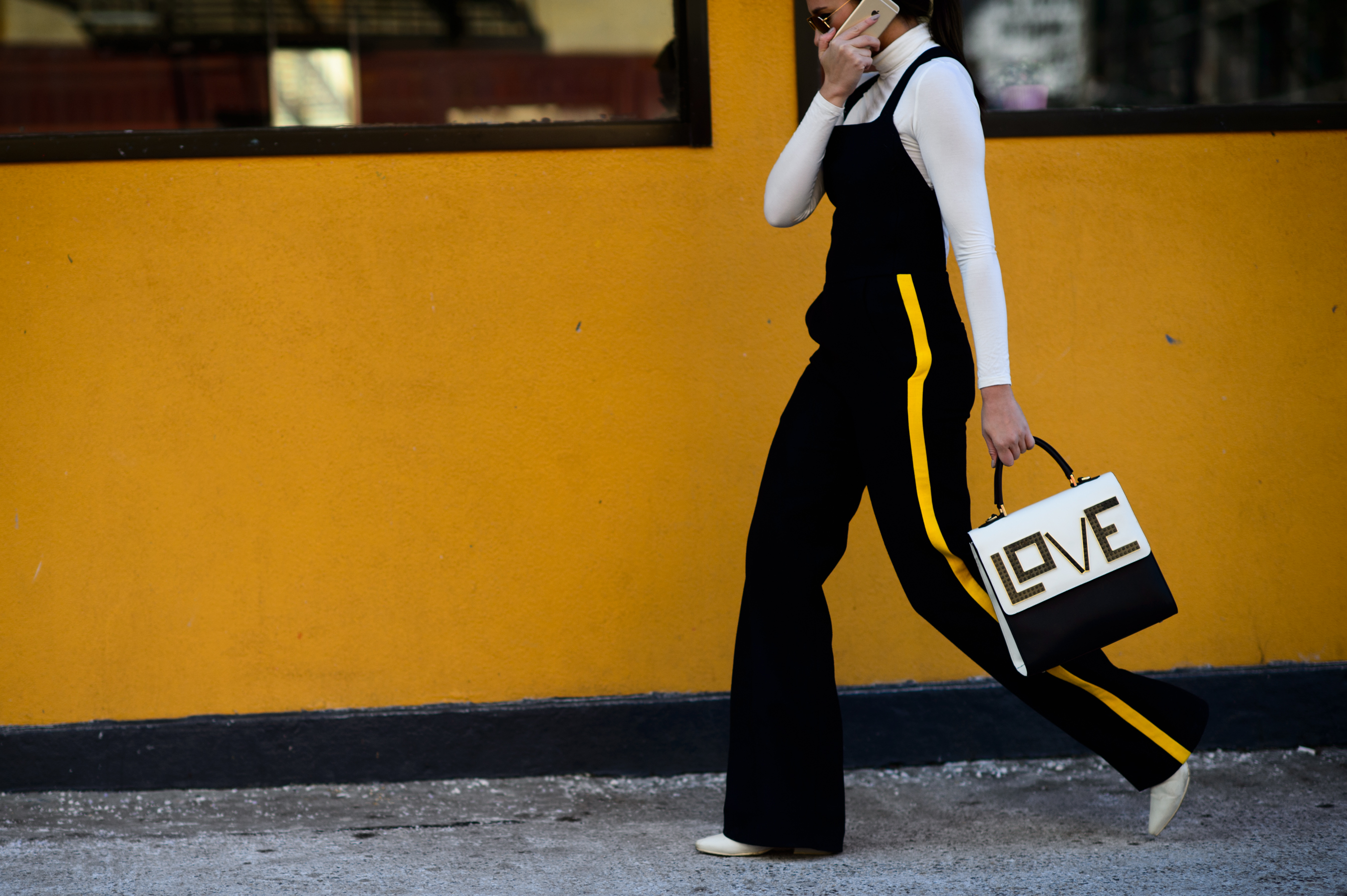 Woman wearing pants with yellow stripe