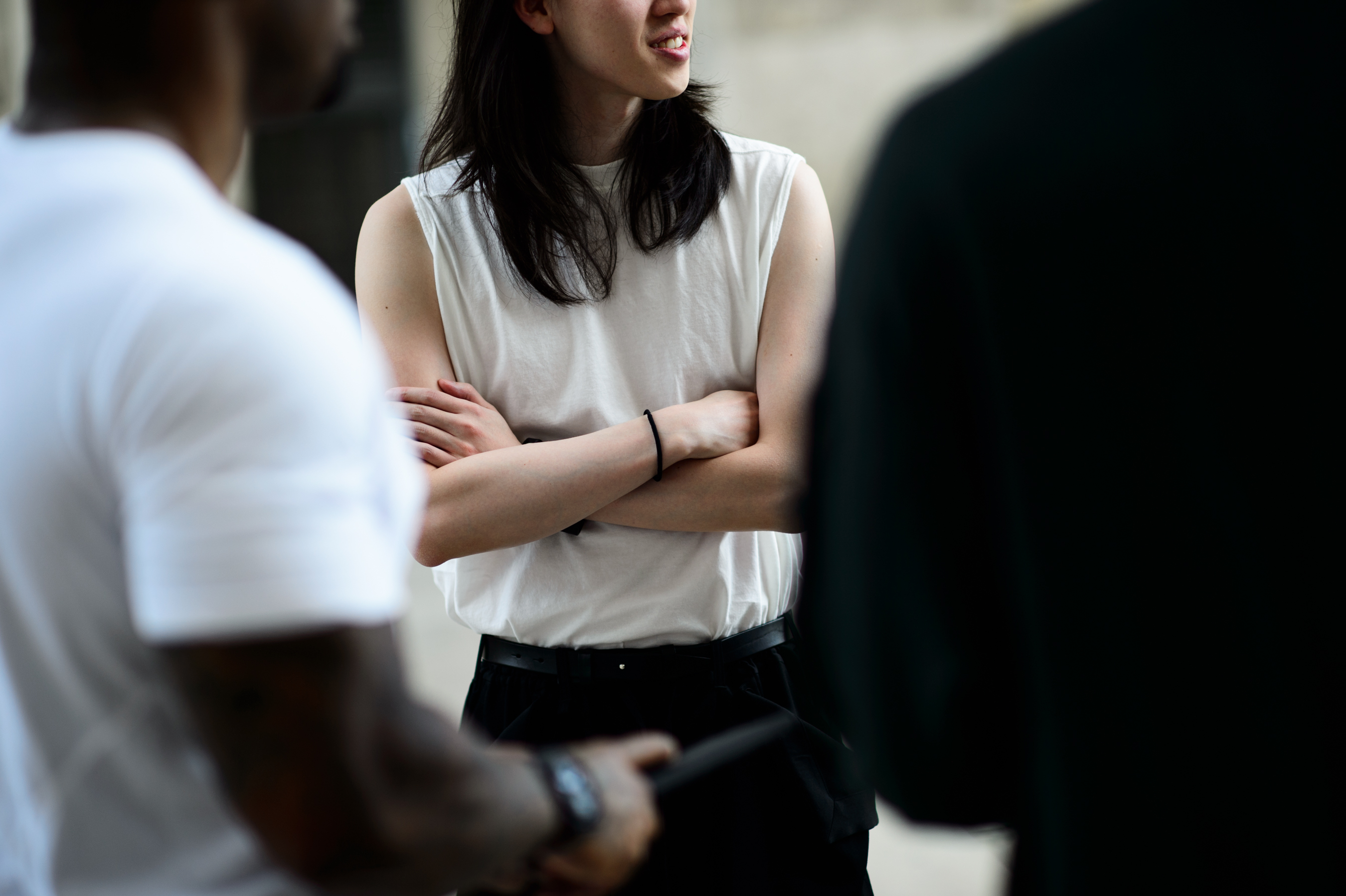 Man with long hair wearing white sleeveless shirt