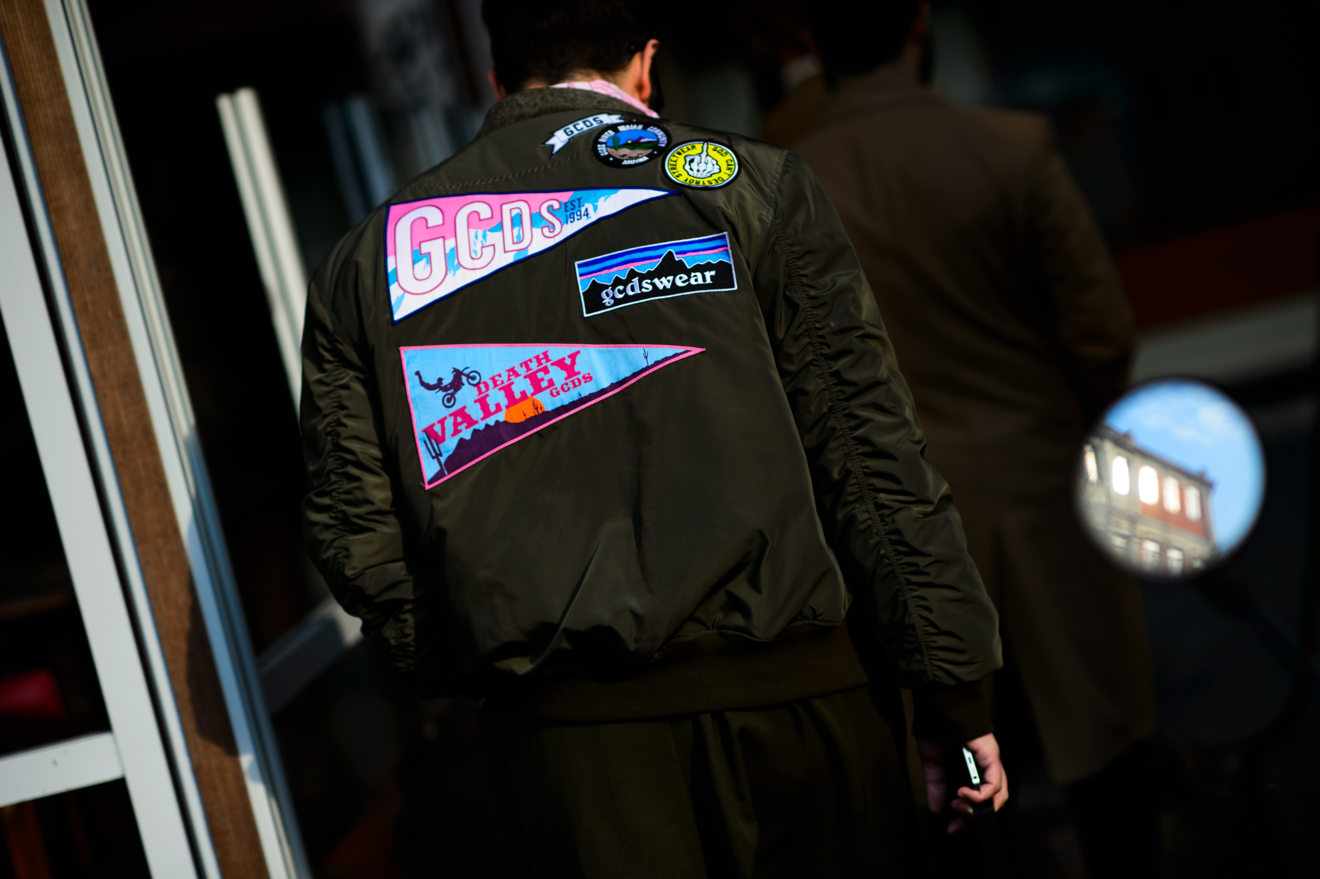 Man wearing jacket with partches
