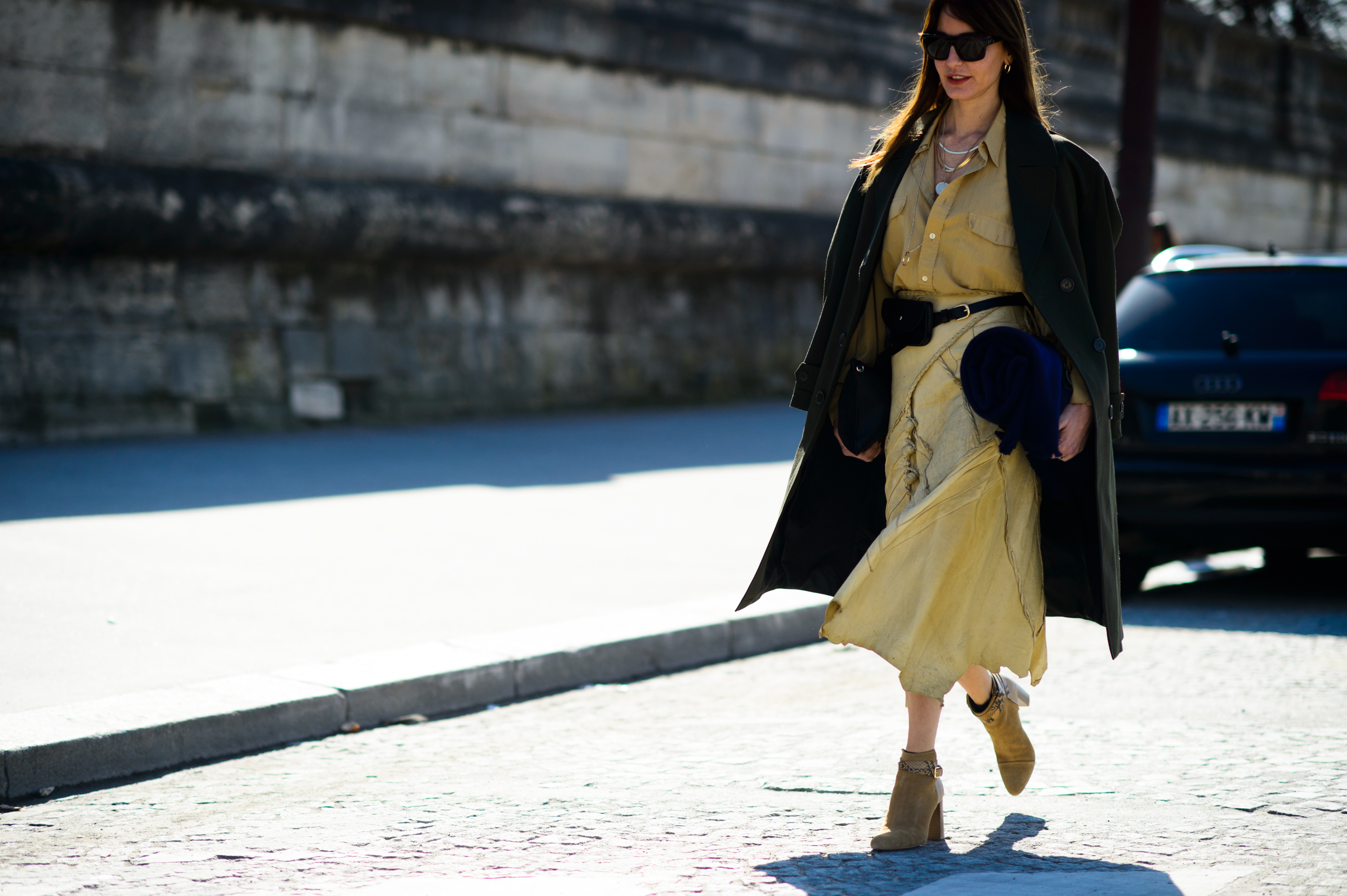 Turkish stylist wearing safari dress and green coat