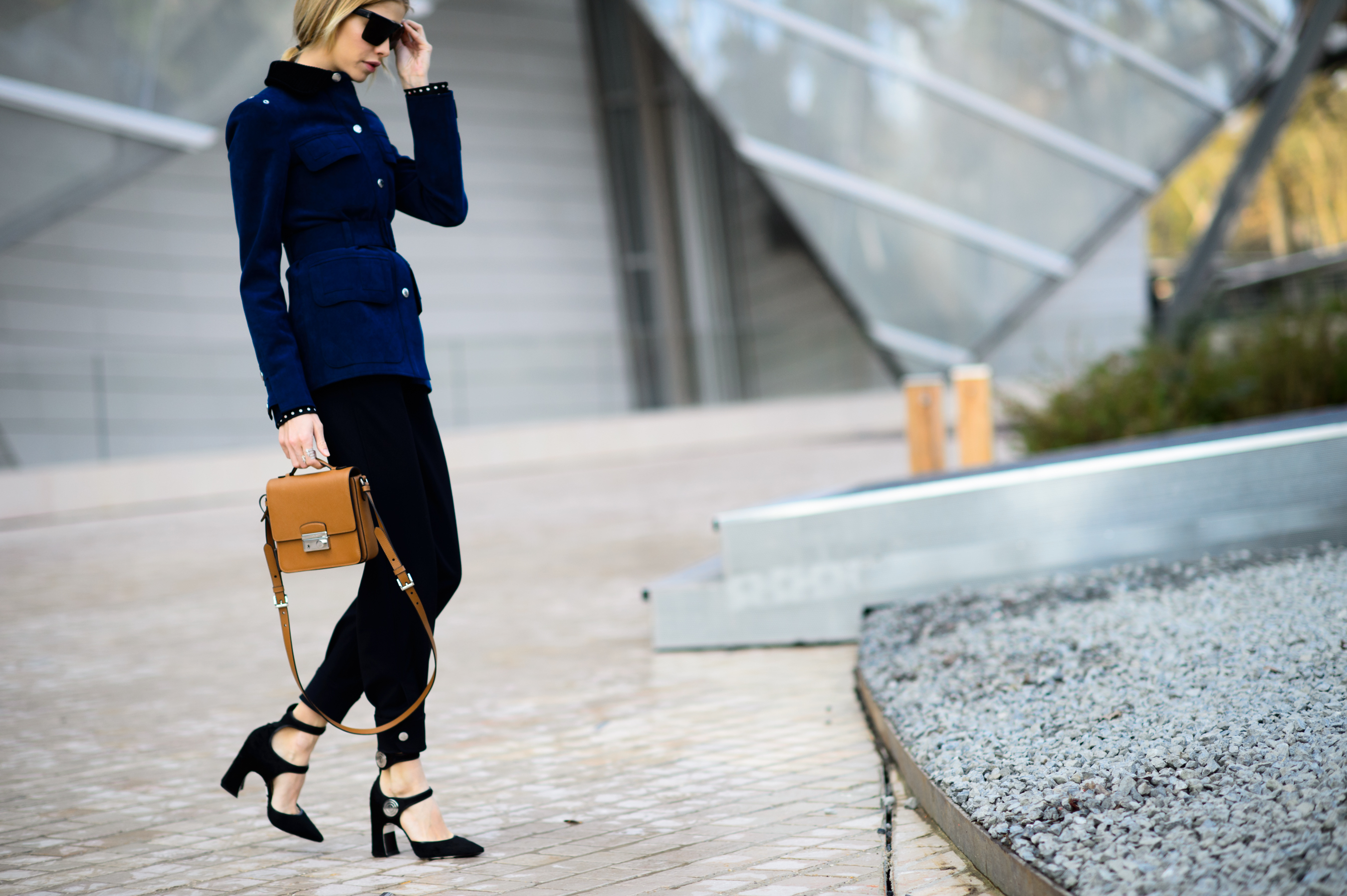 Russian woman wearing blue jacket and brown bag