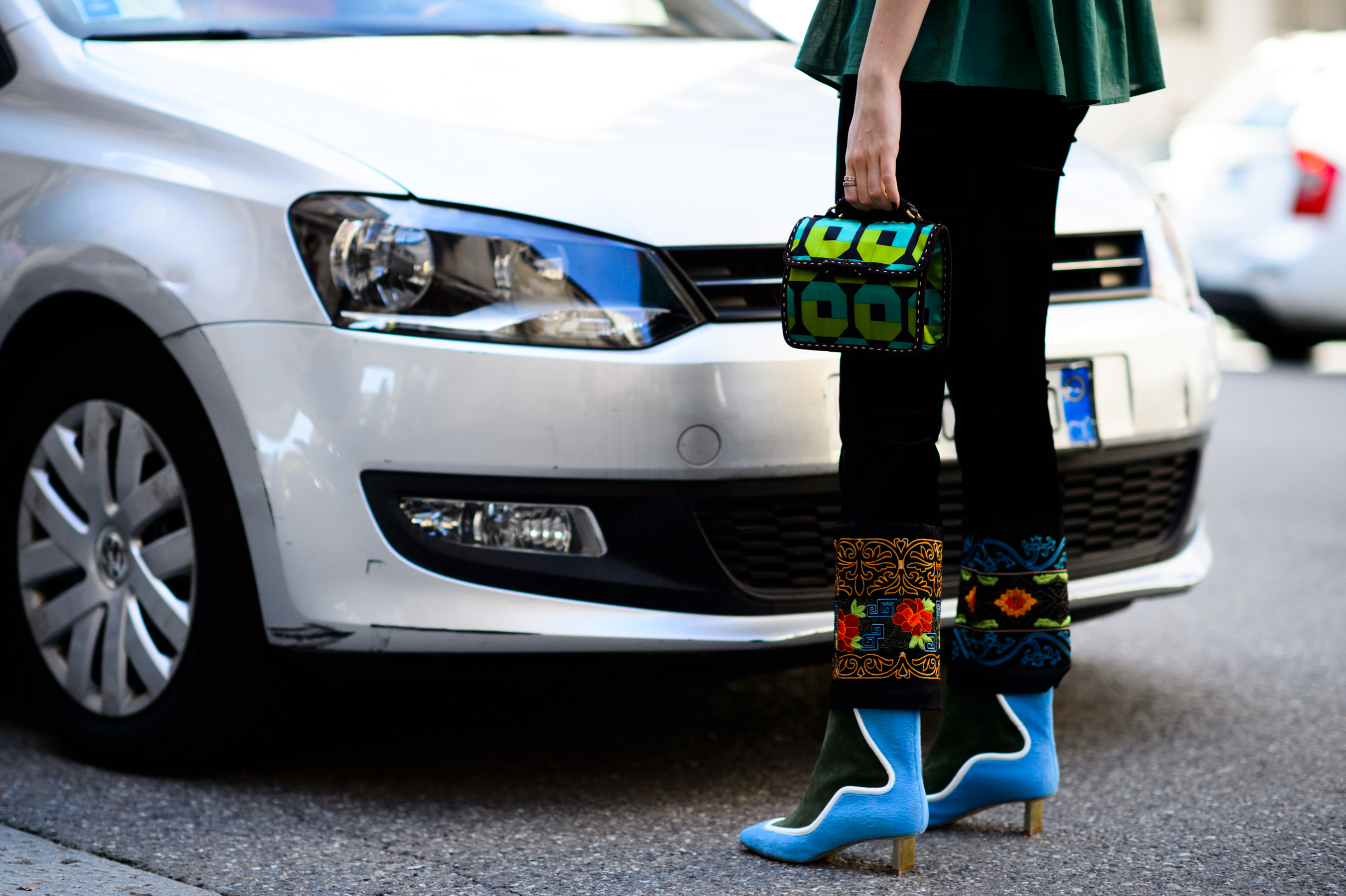 Close up of embroidered pants and blue shoes