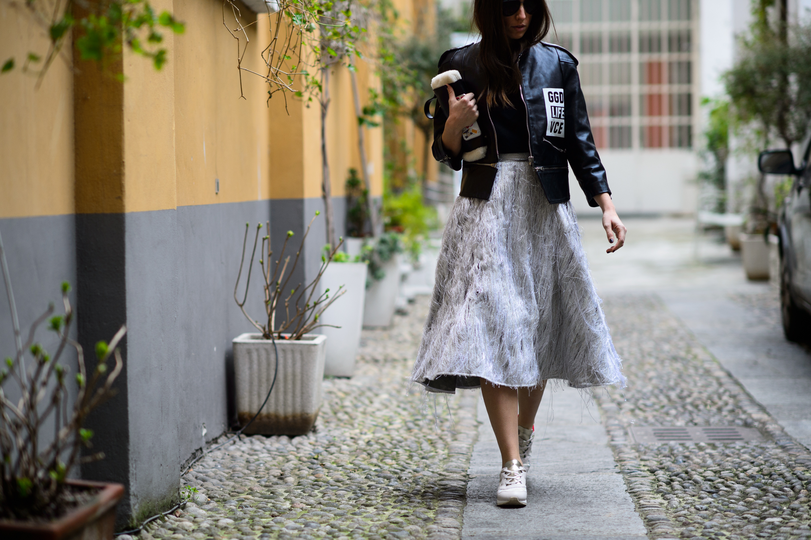 Woman wearing leather jacket and long skirt