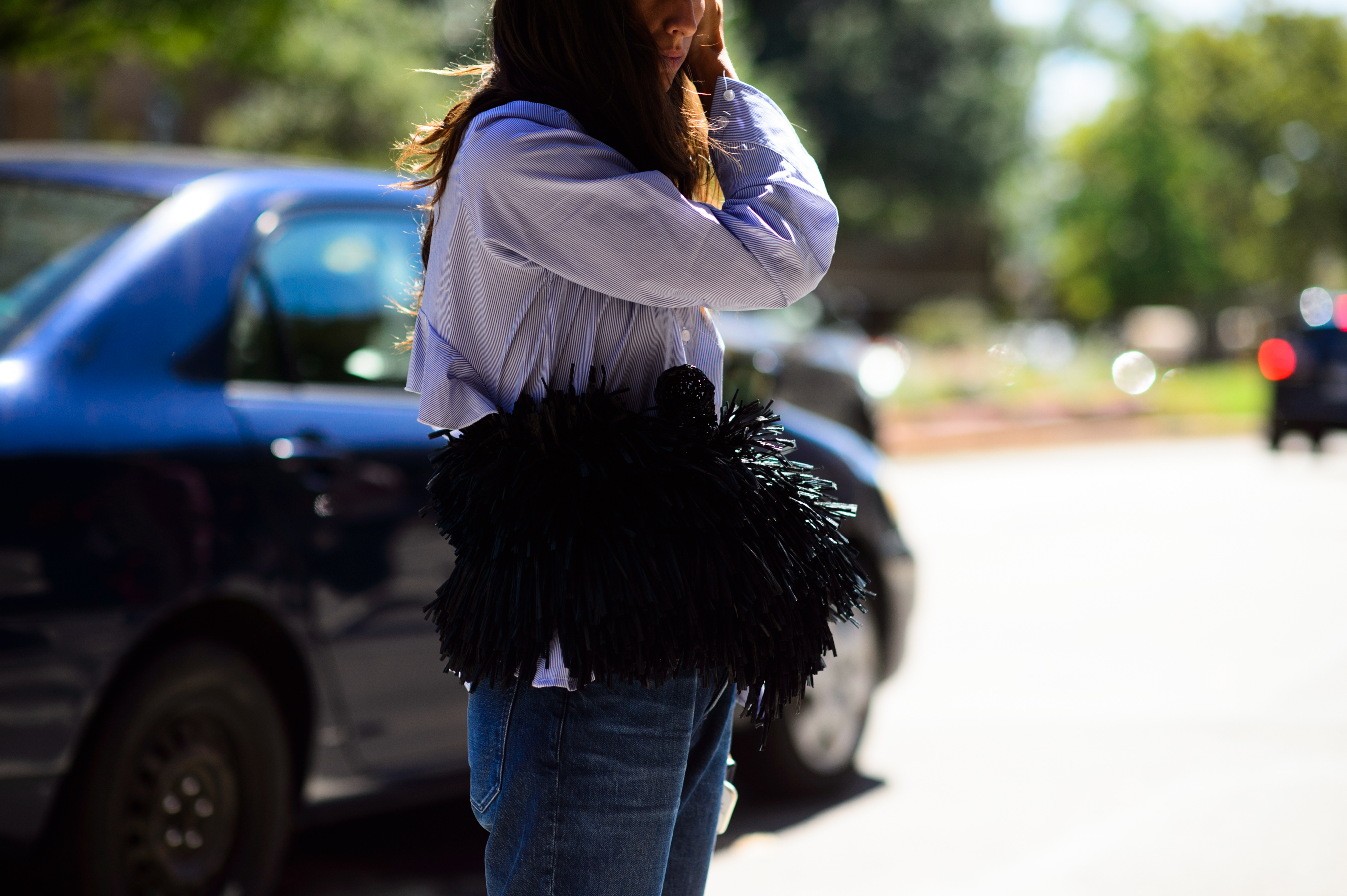 Woman wearing belt with feathers over her waist