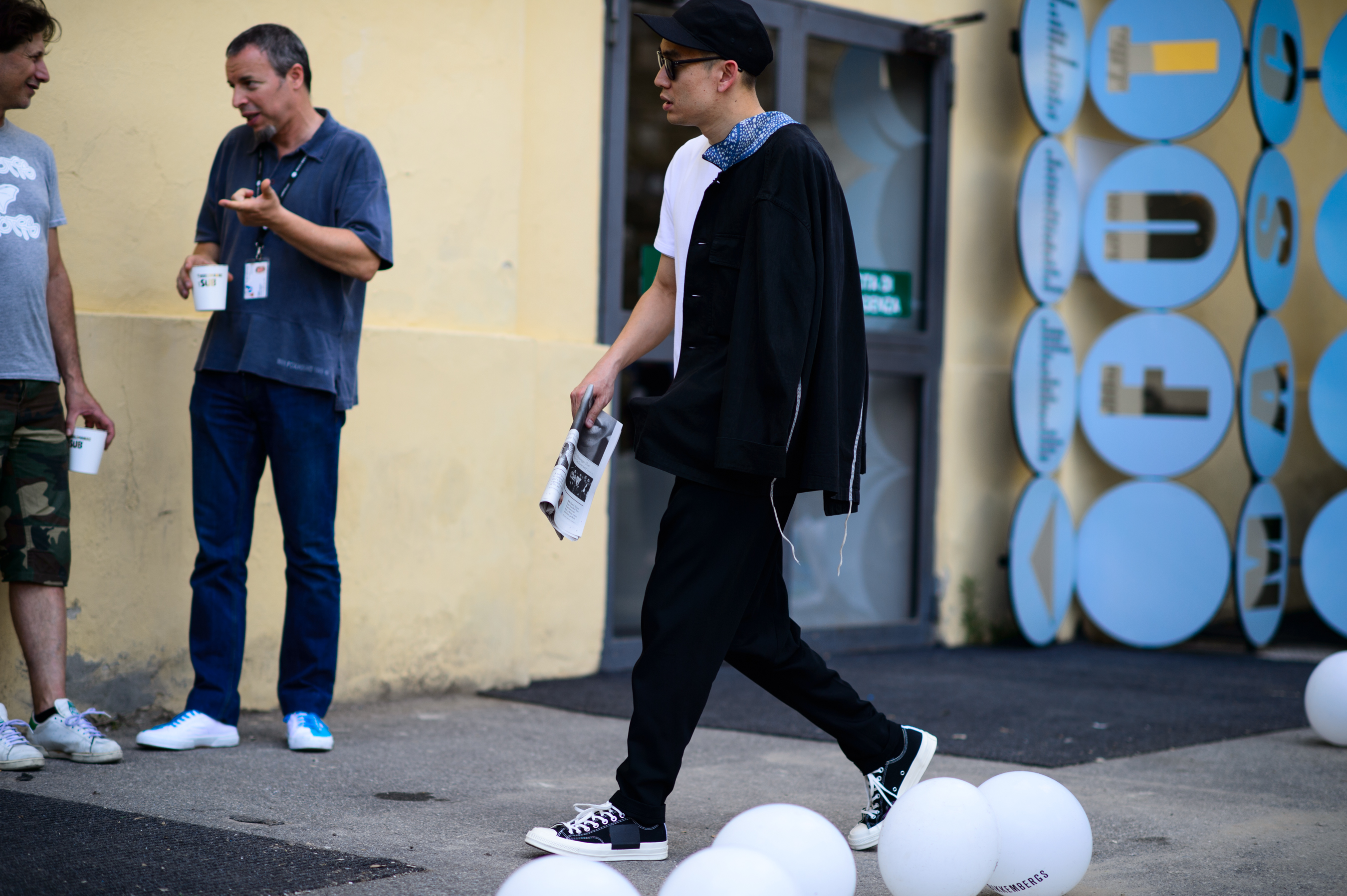 Man holding news paper at the menswear exhibition