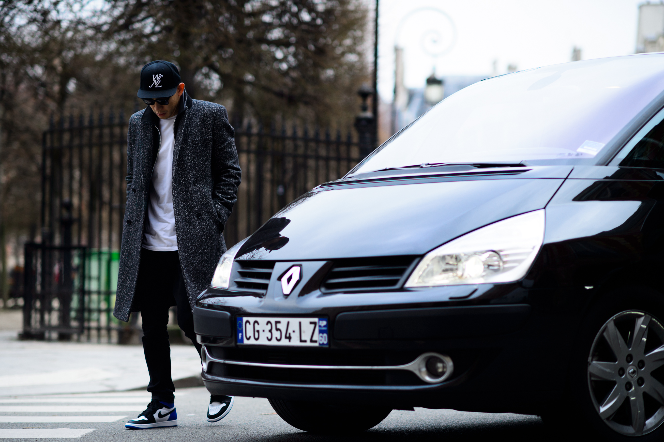 Man wearing coat and sneakers