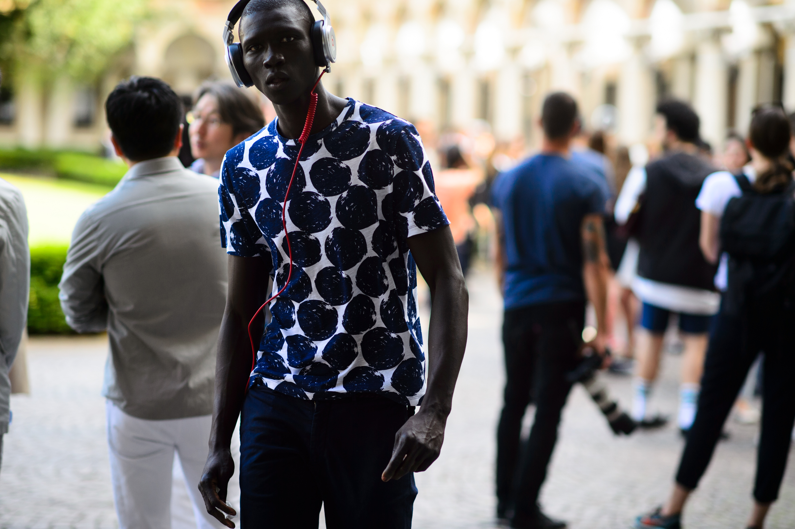 African male model wearing headphones after the show