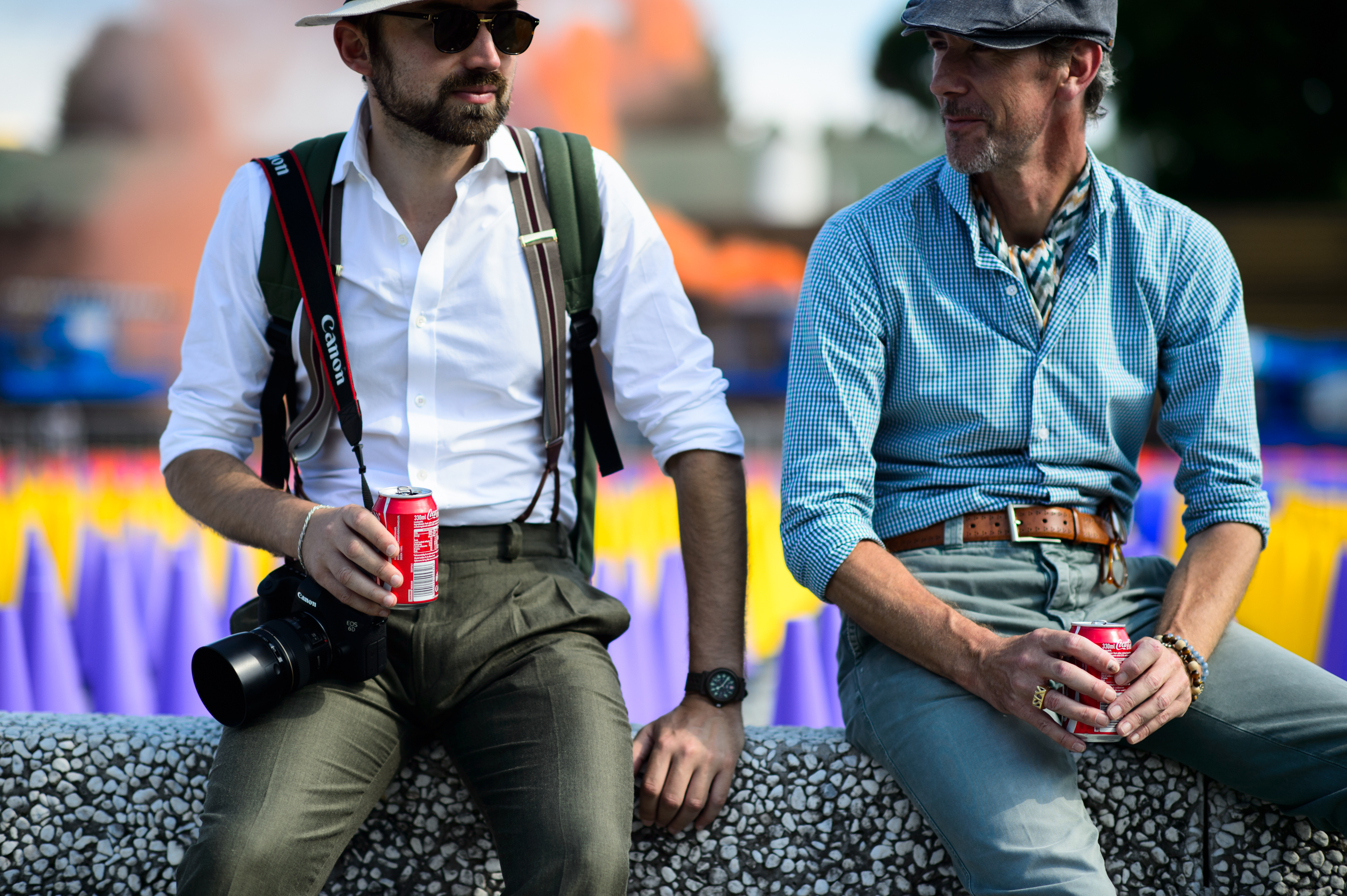 Two men sitting wearing shirts
