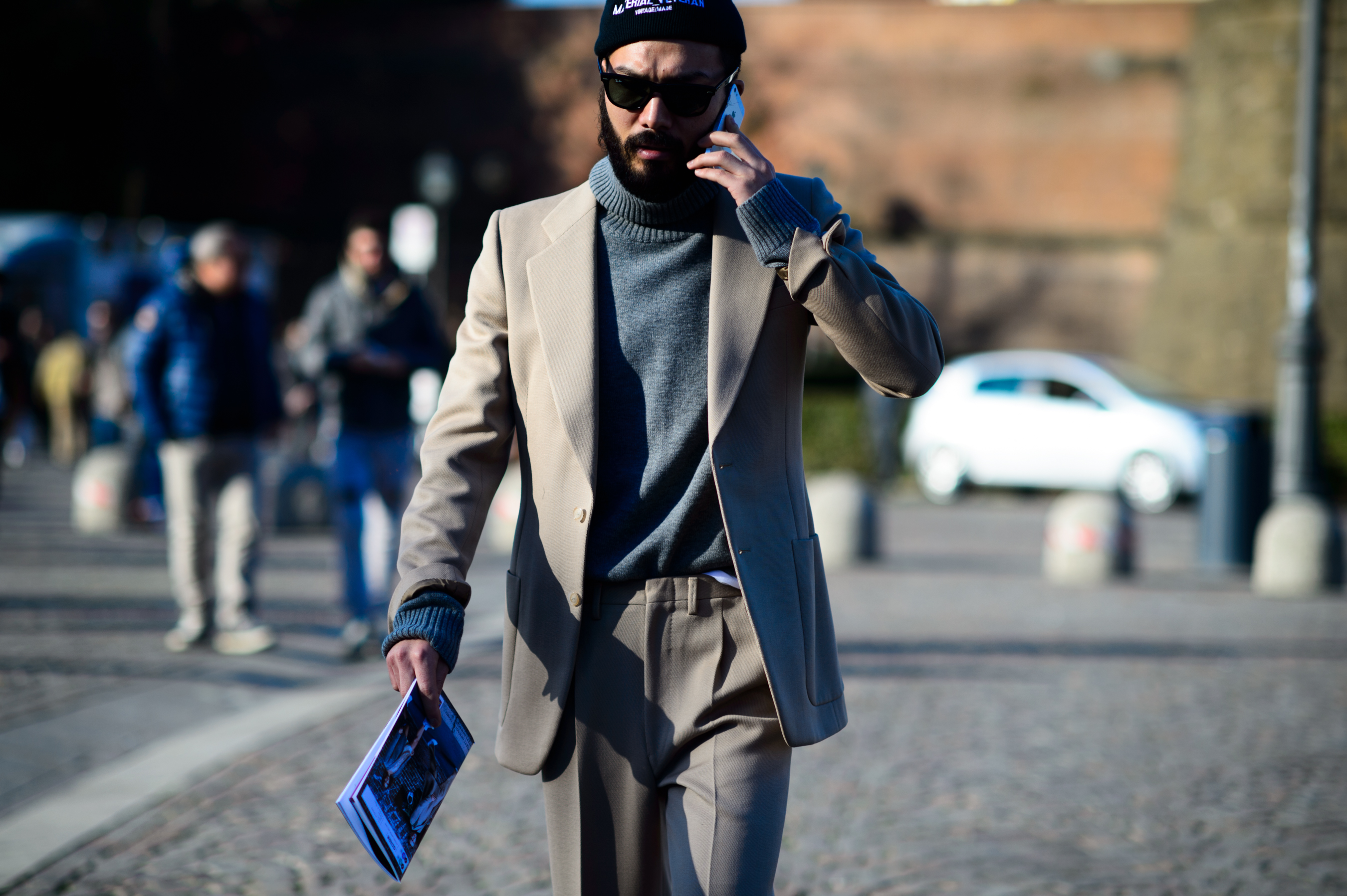 Man wearing beige suit and sweater