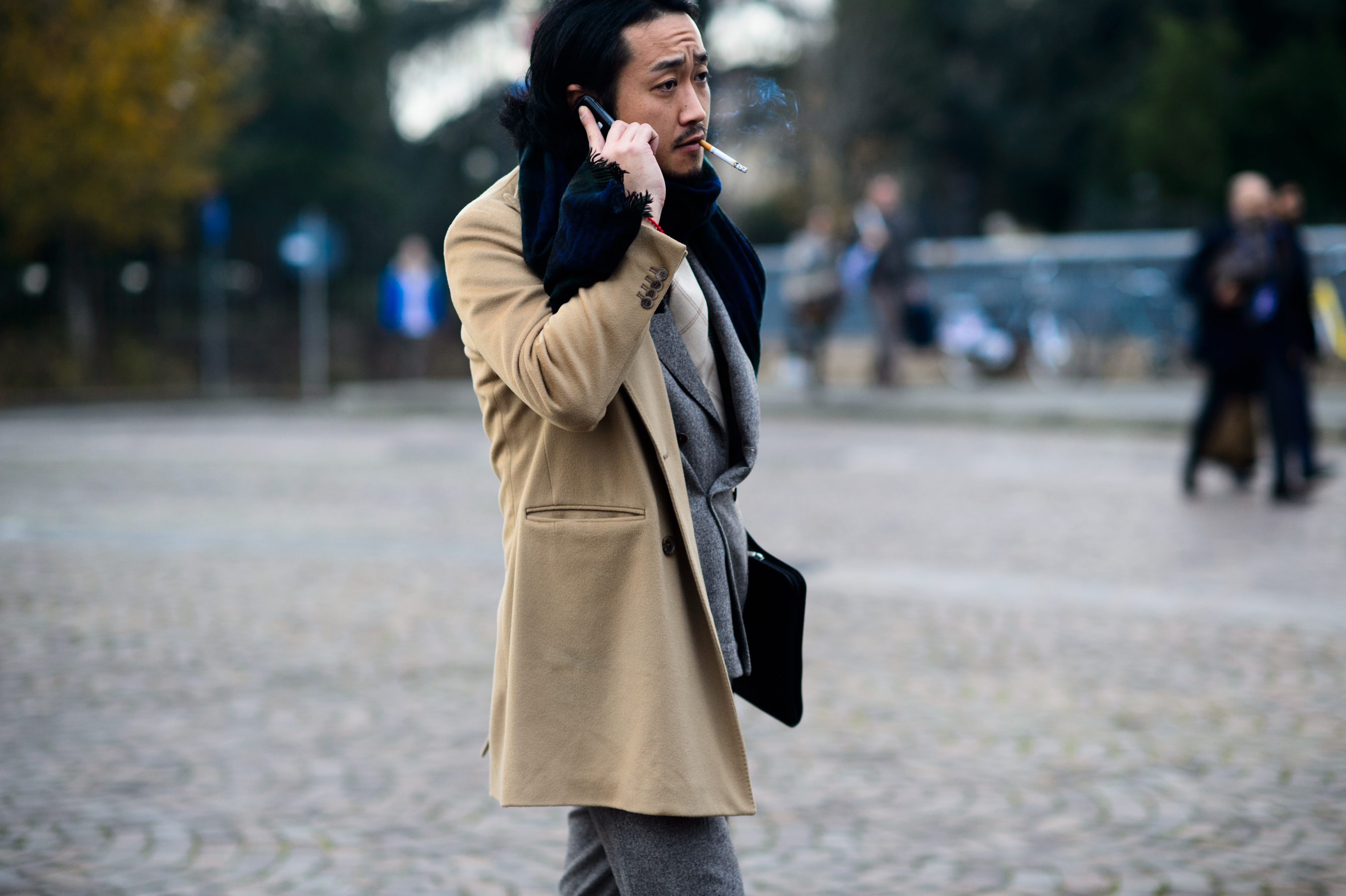 Man smoking in beige coat