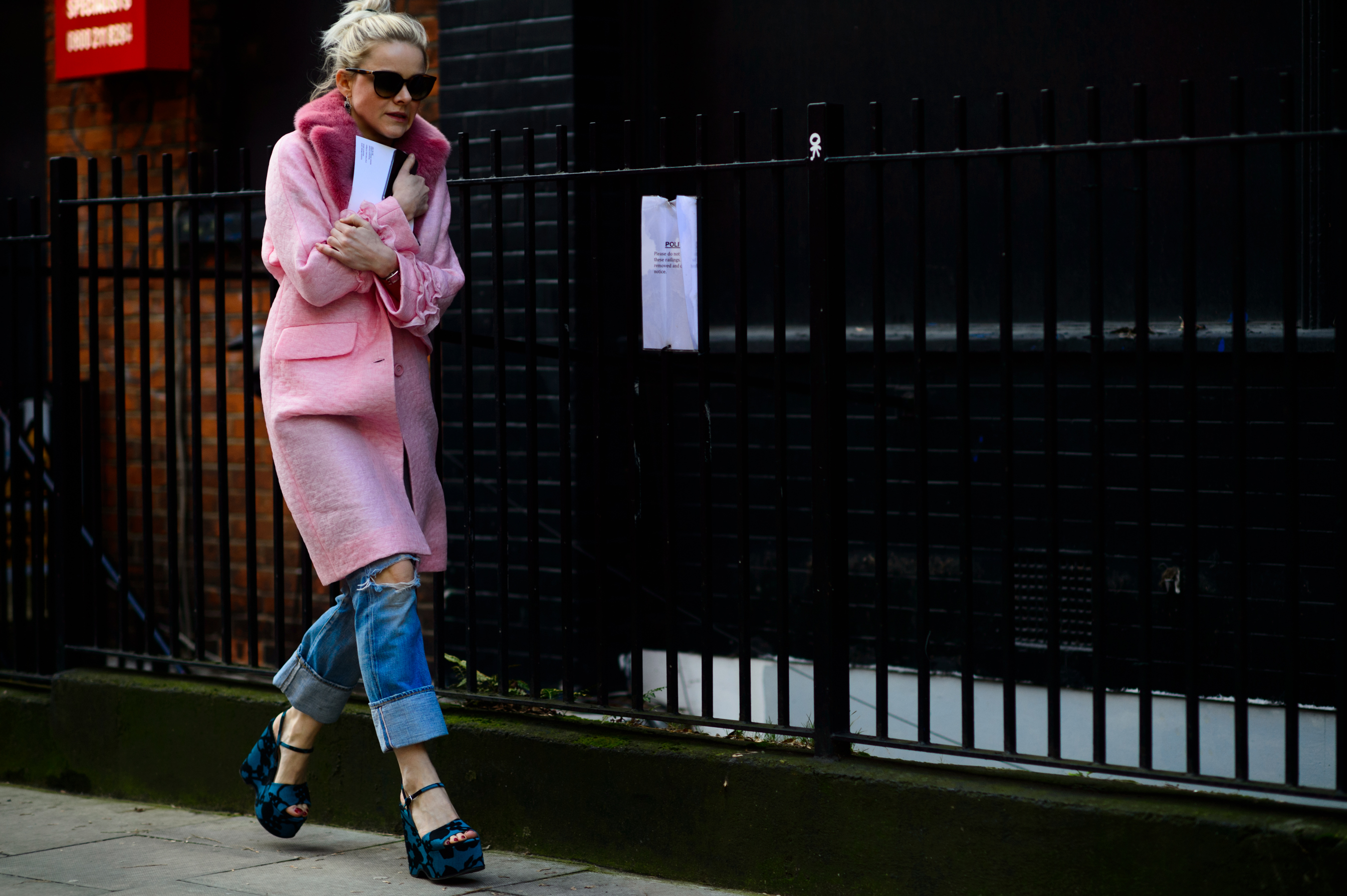 Woman wearing pink coat and sandals