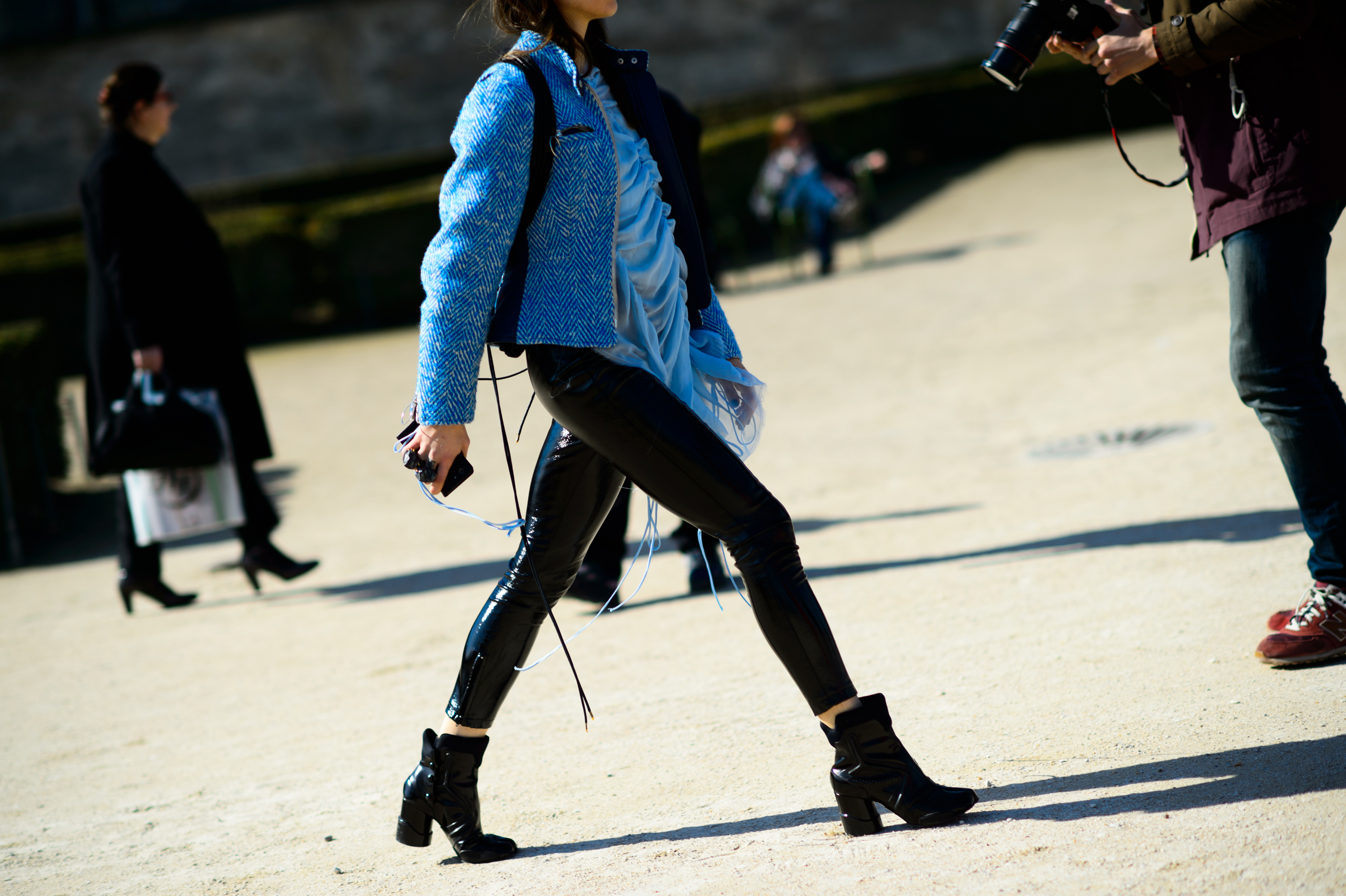 Woman wearing latex leggings and blue jacket