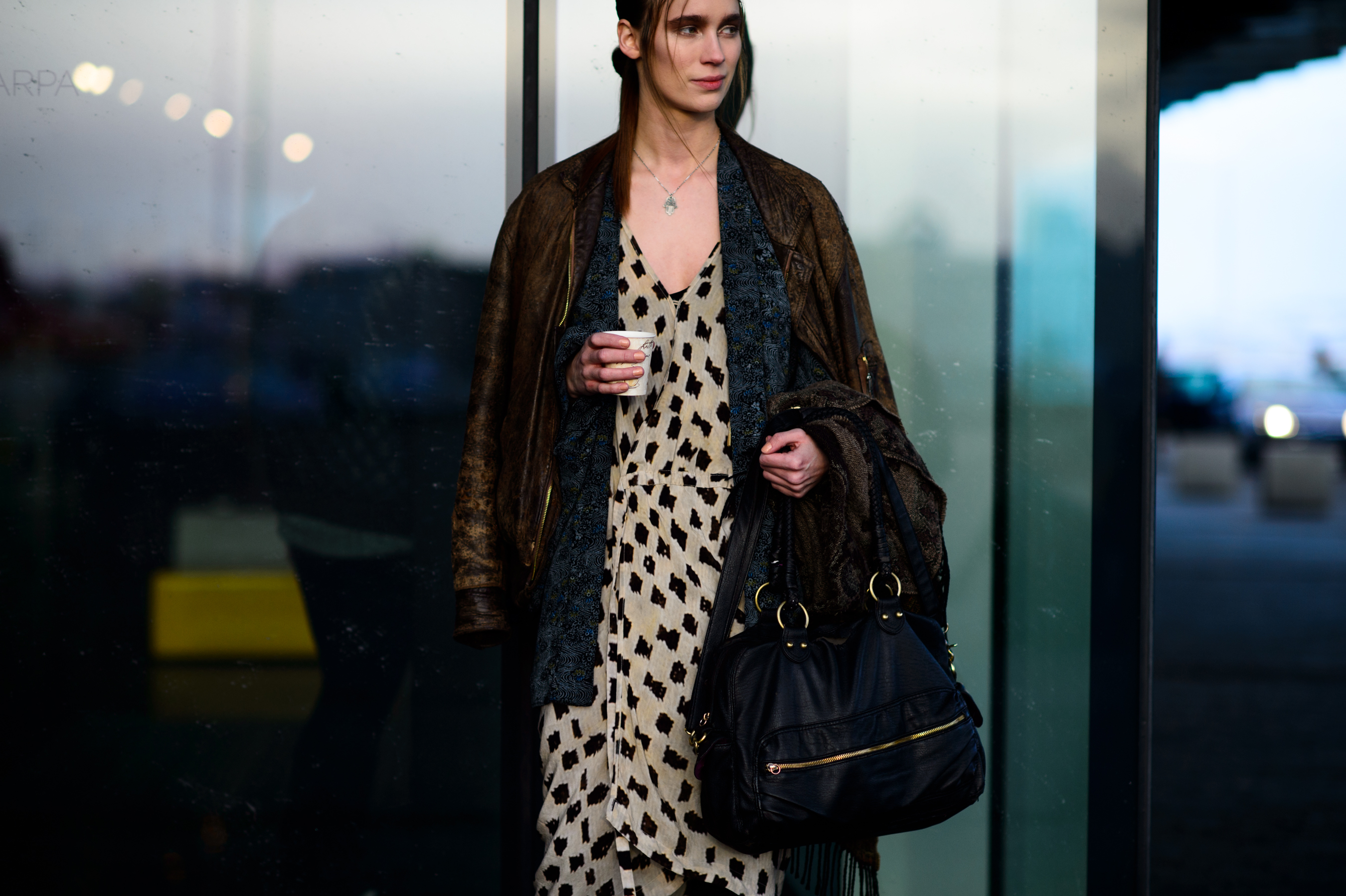 Model holding coffee cup after the show