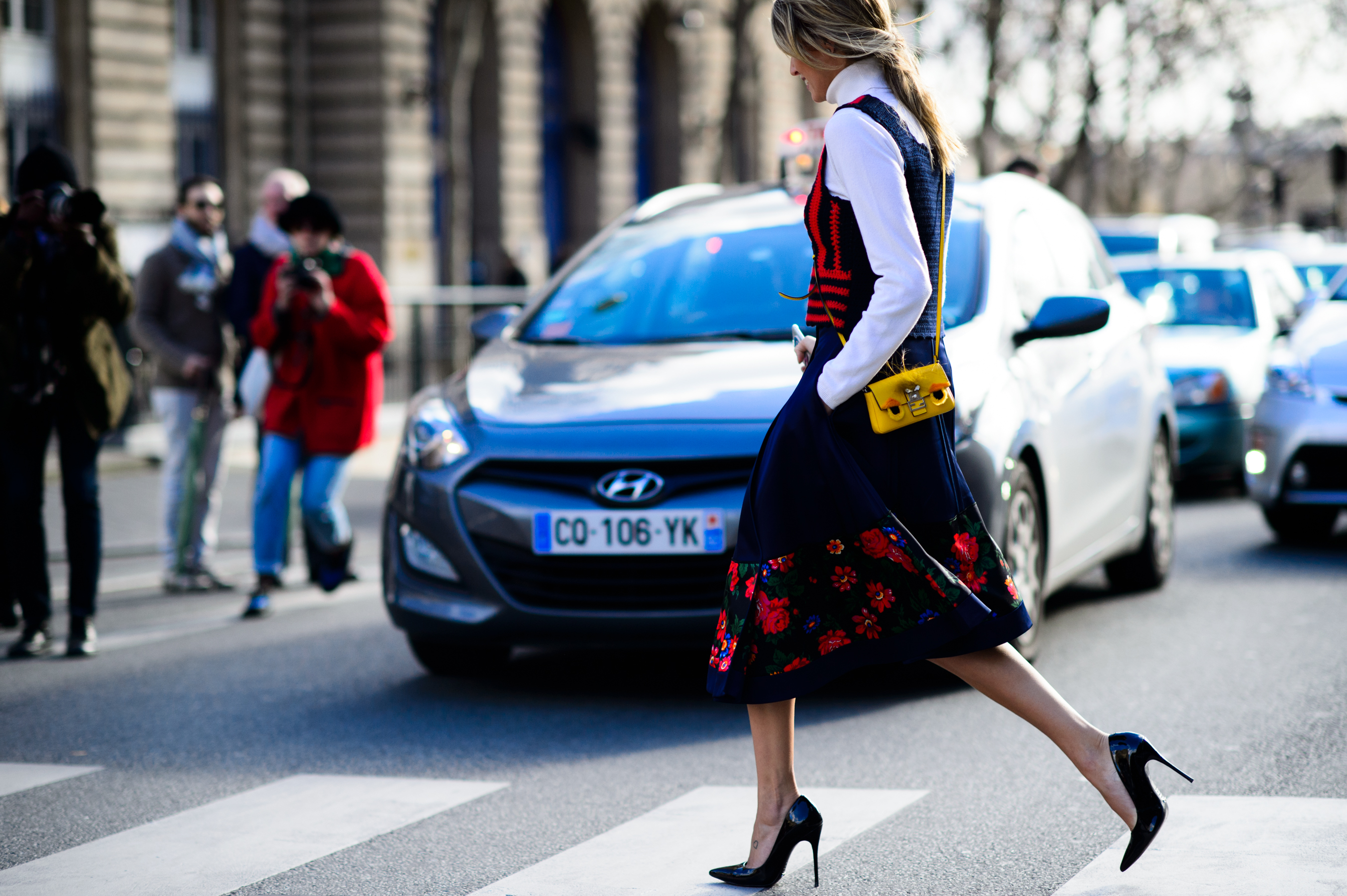 Woman in flower printed skirt crossing the street