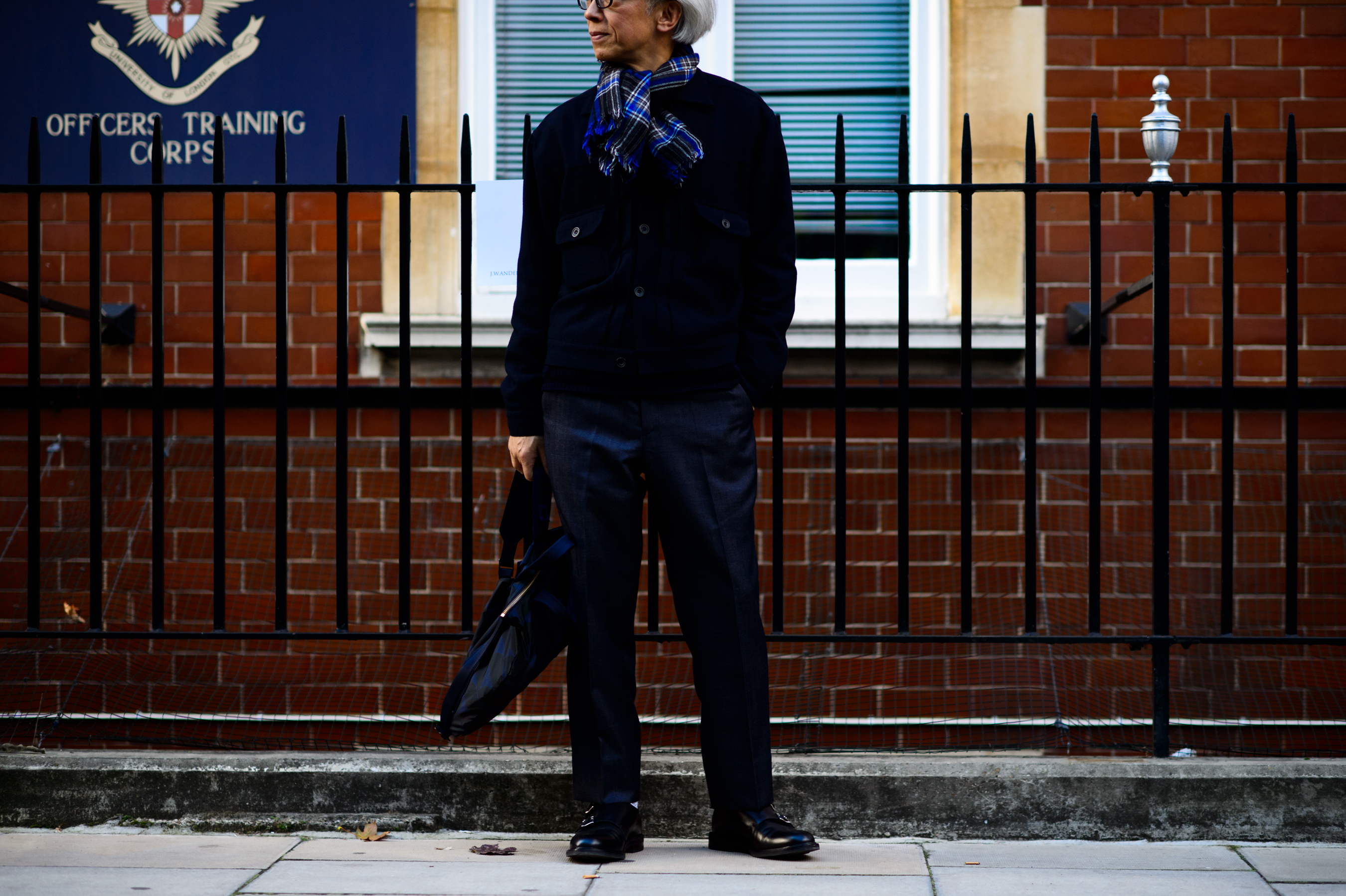 Japanese man in front of the red brick wall