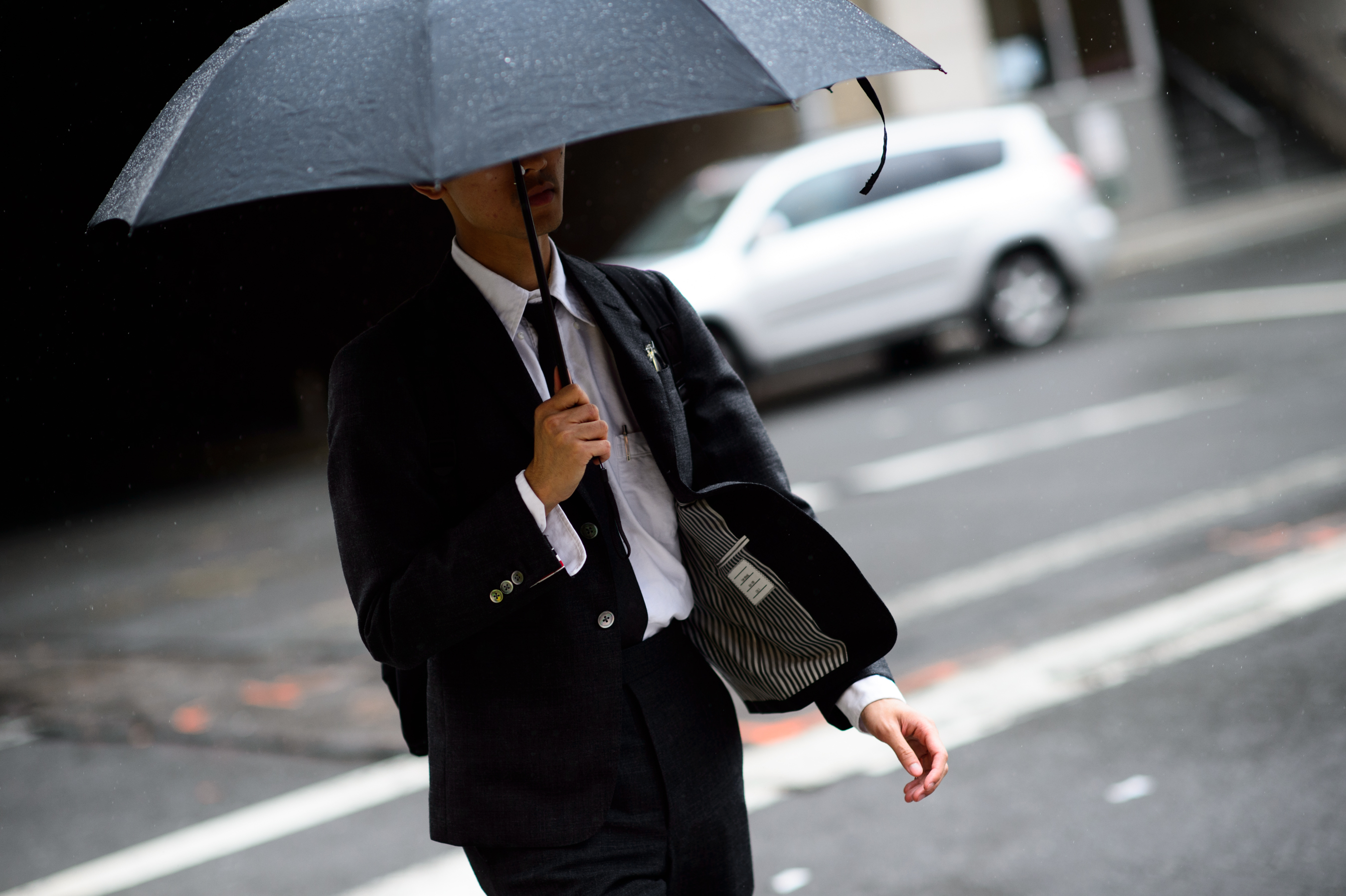 Man in a suit holding an umbrella
