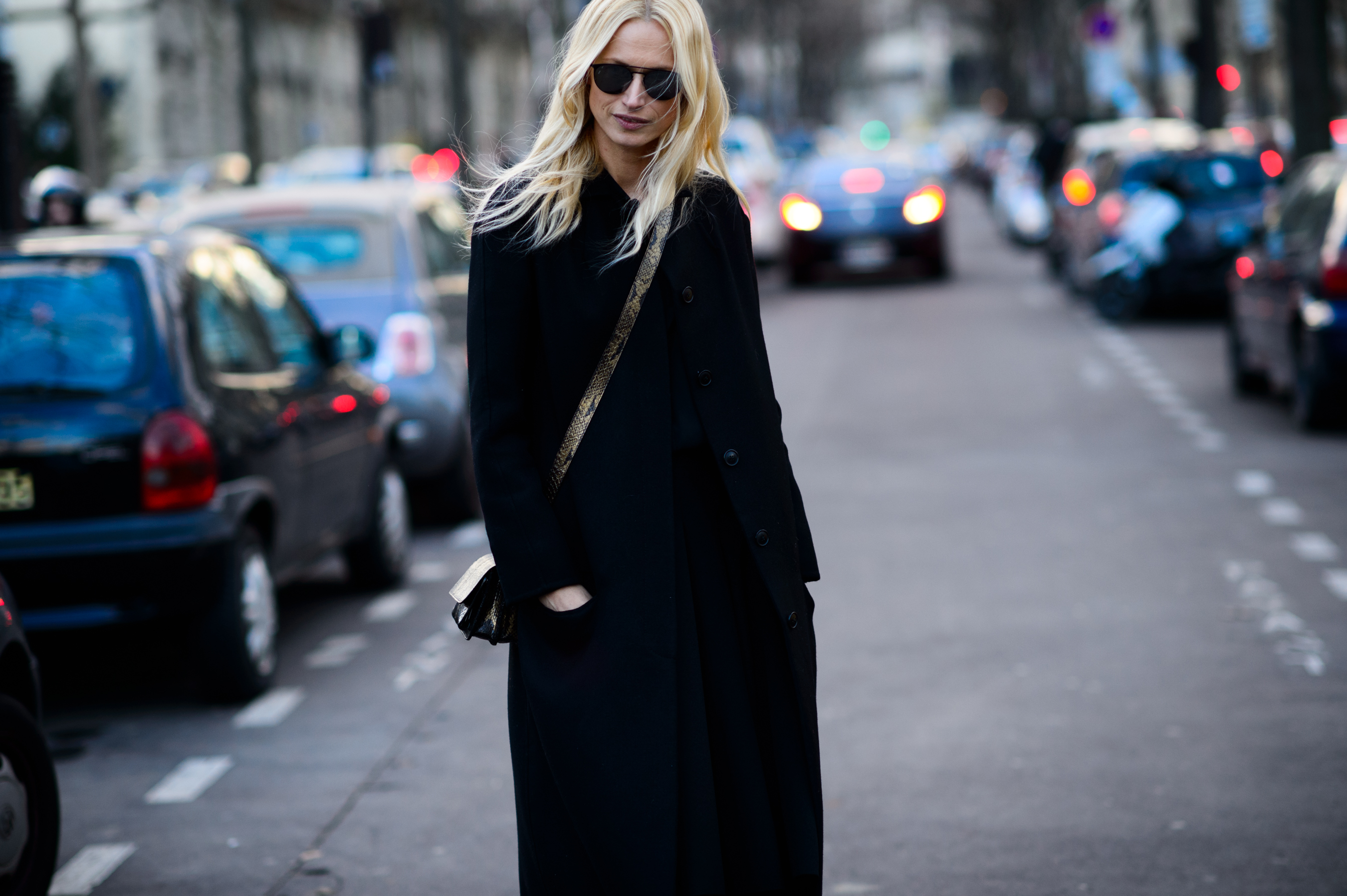 Blonde model wearing black coat