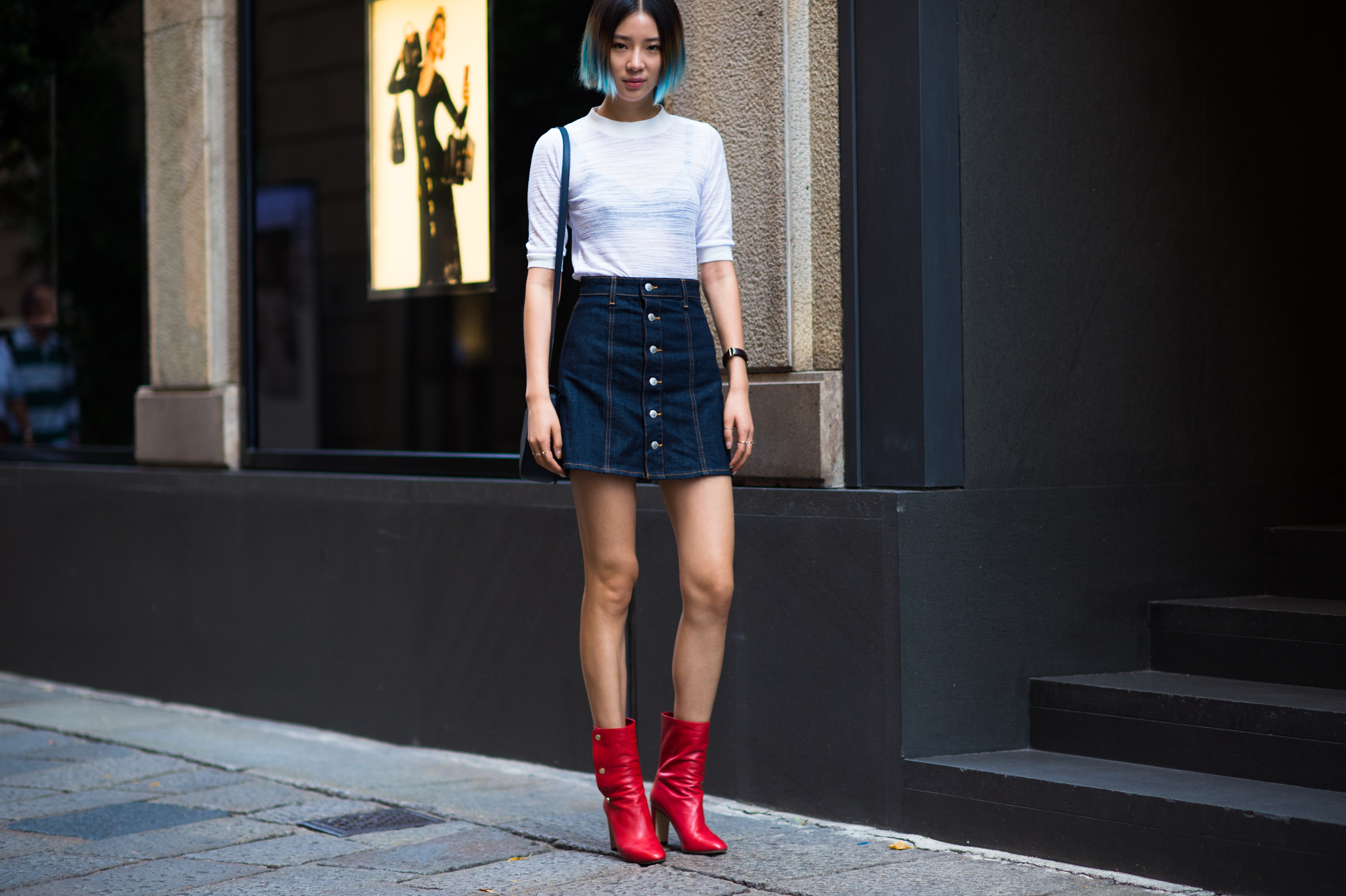 Korean model and journalist wearing short denim skirt and red boots