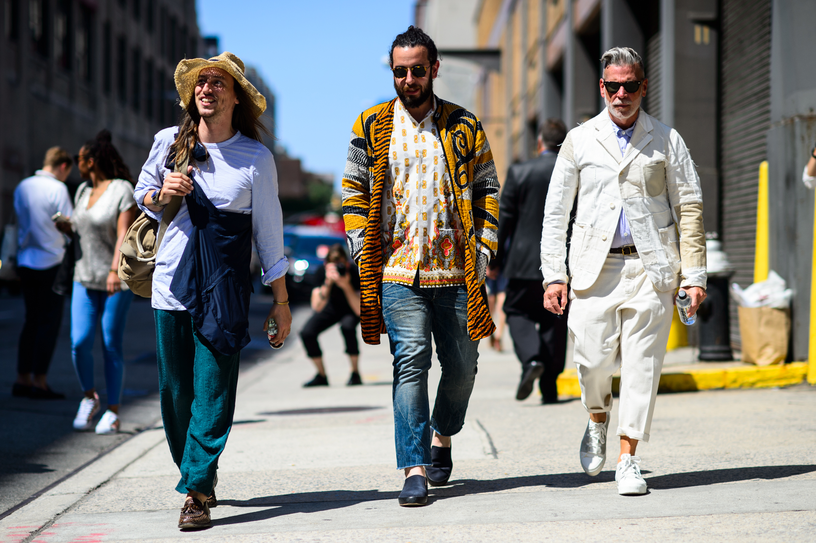 Three men walking down the street