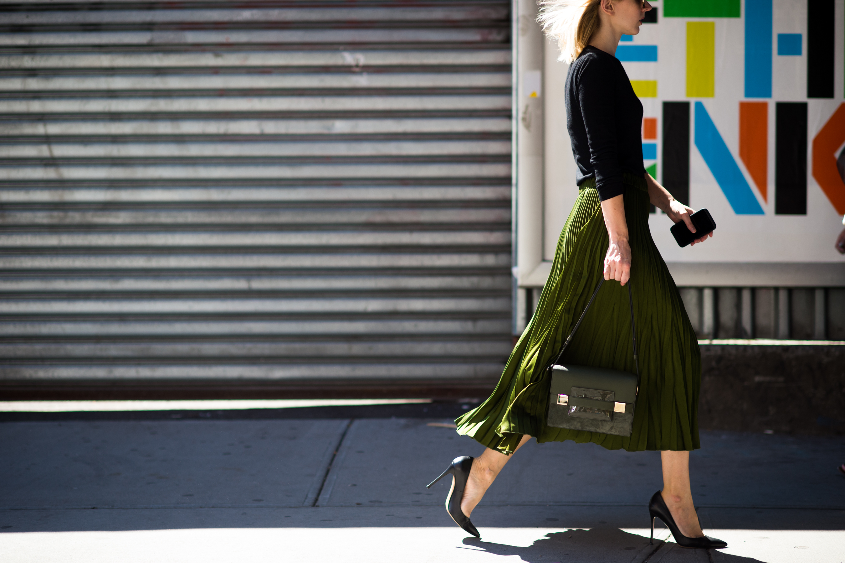 Woman wearing green skirt and high heels