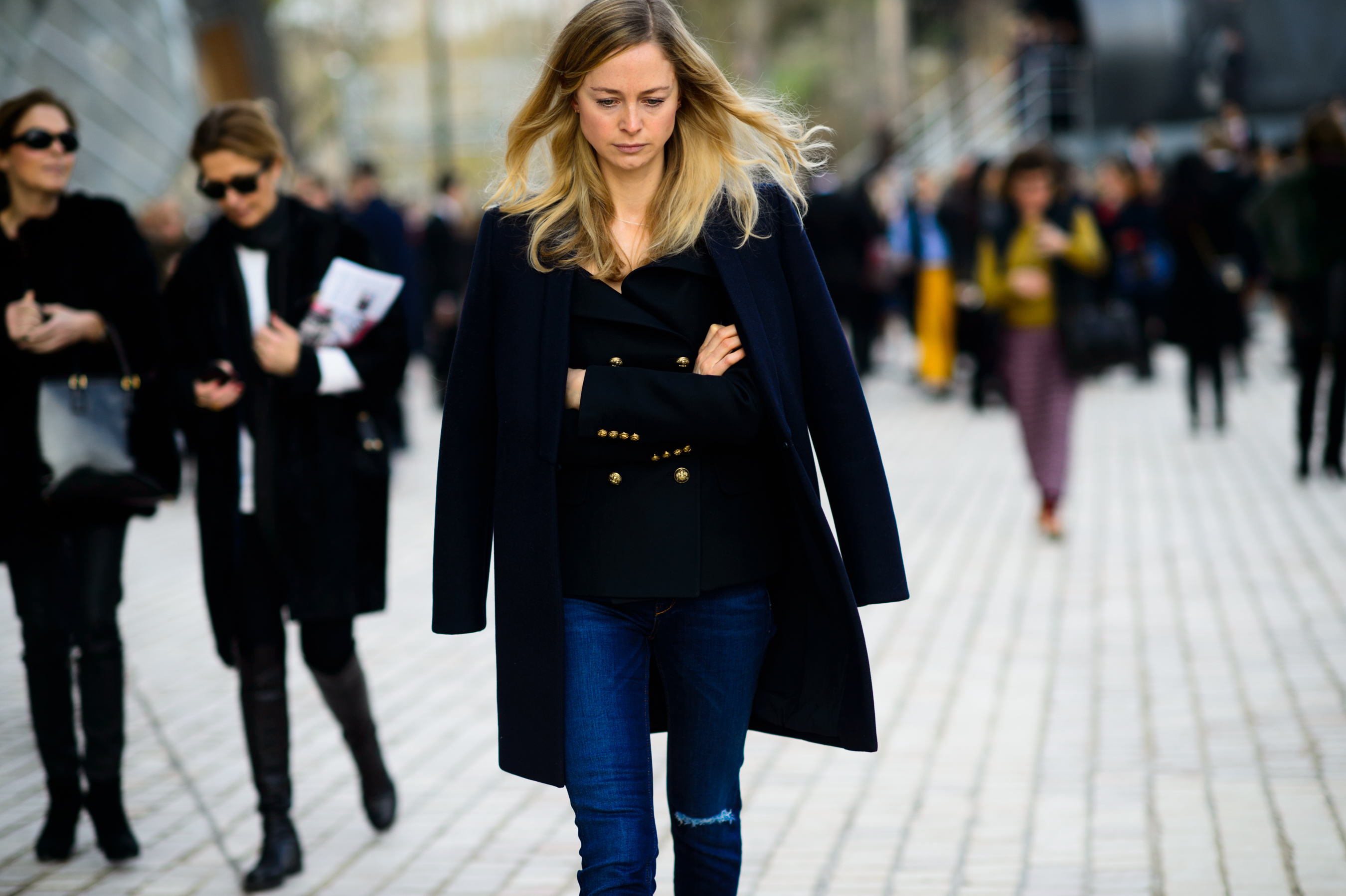 Woman wearing dark coat and denim