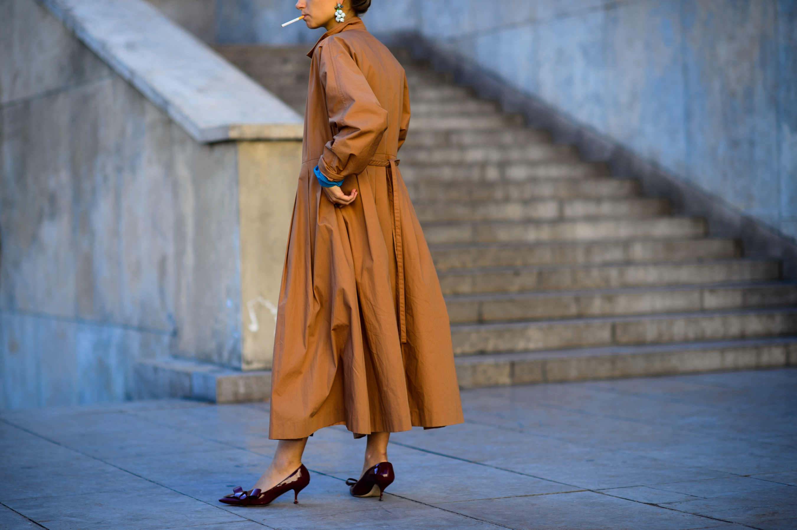 American illustrator wearing brown trench coat