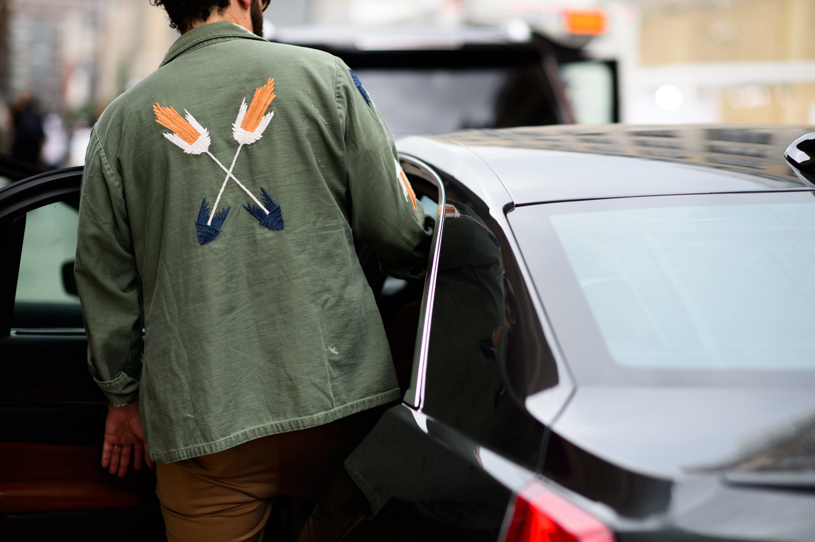 Editor wearing green jacket getting in the car