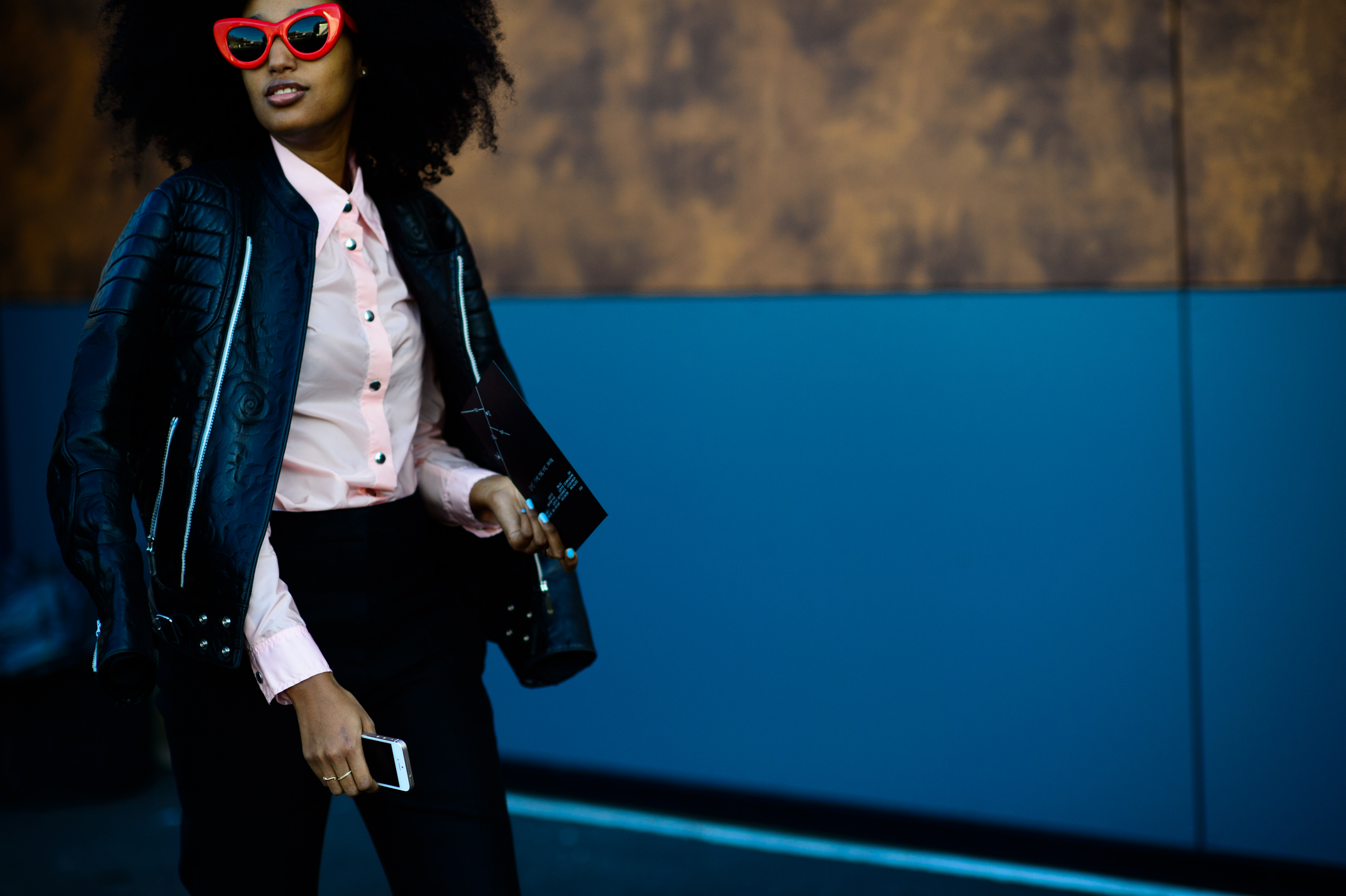 Woman wearing red glasses and leather jacket