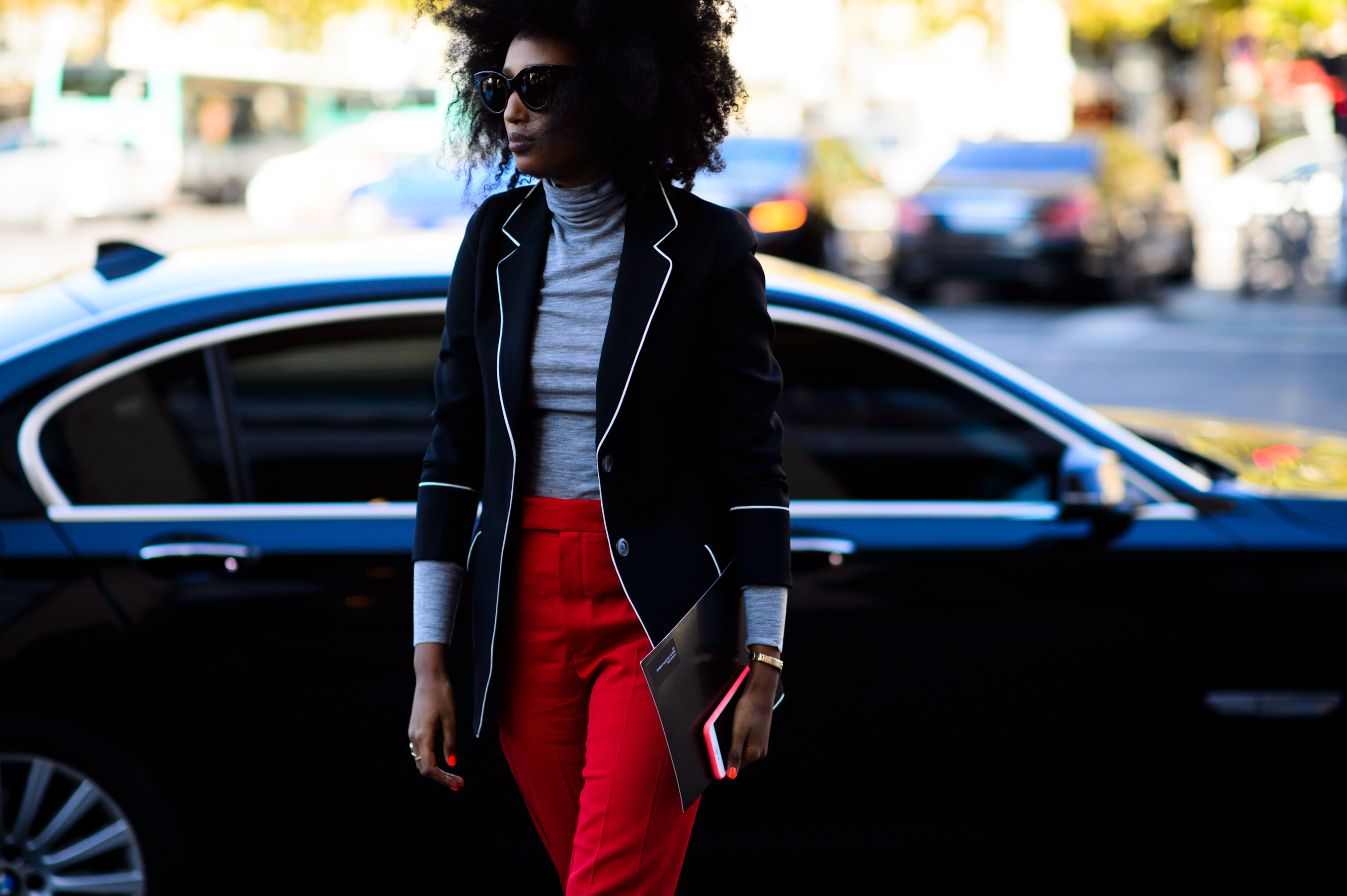 Woman wearing red pants and black jacket