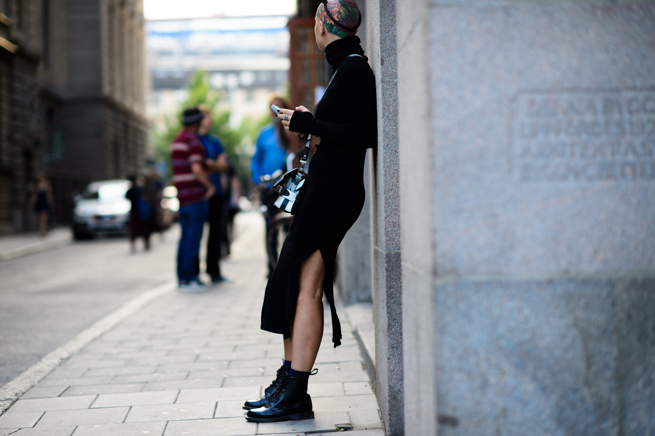 Russian stylist with tattoo on her head wearing black dress