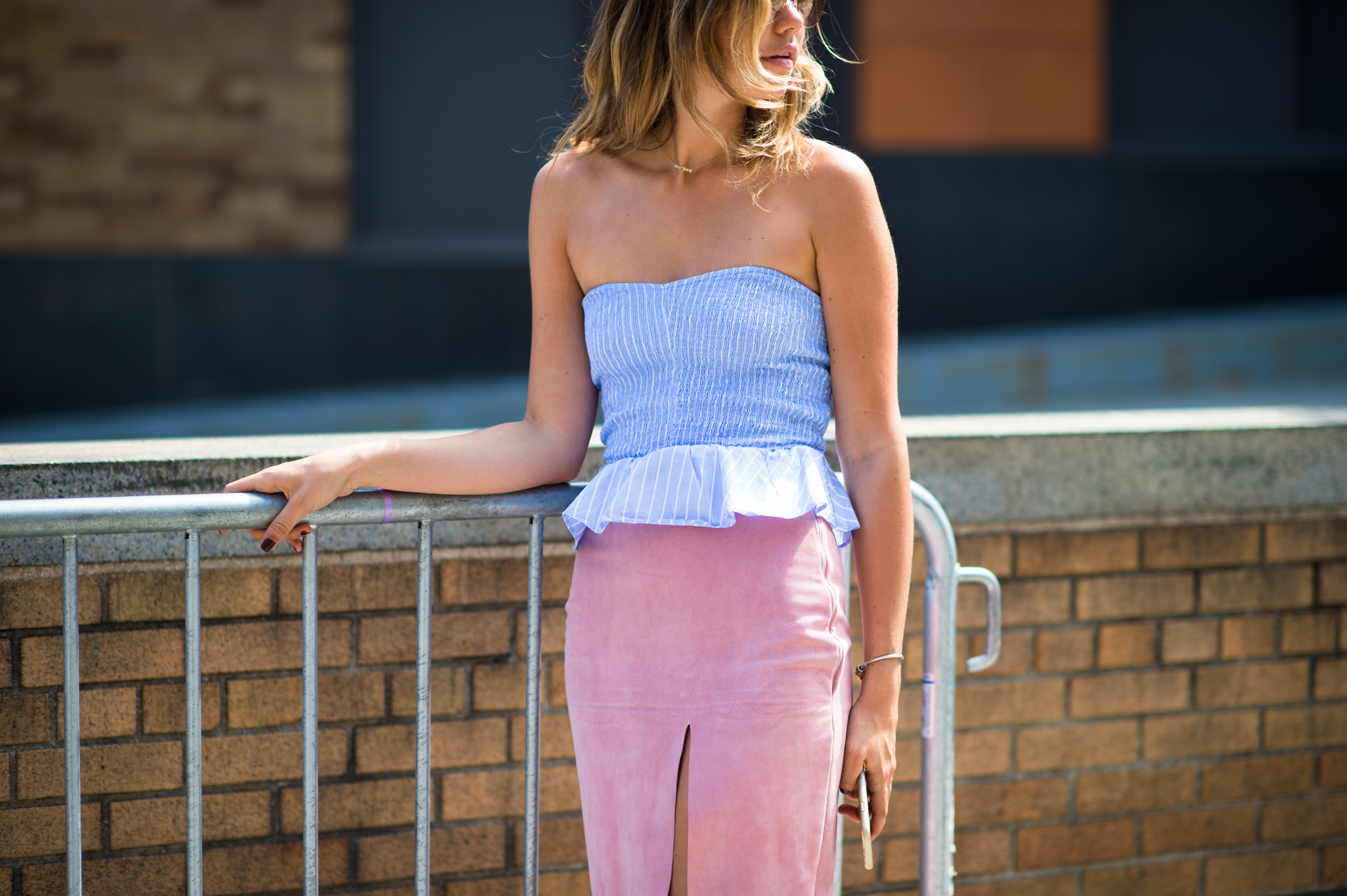 Girl wearing blue top with pink skirt