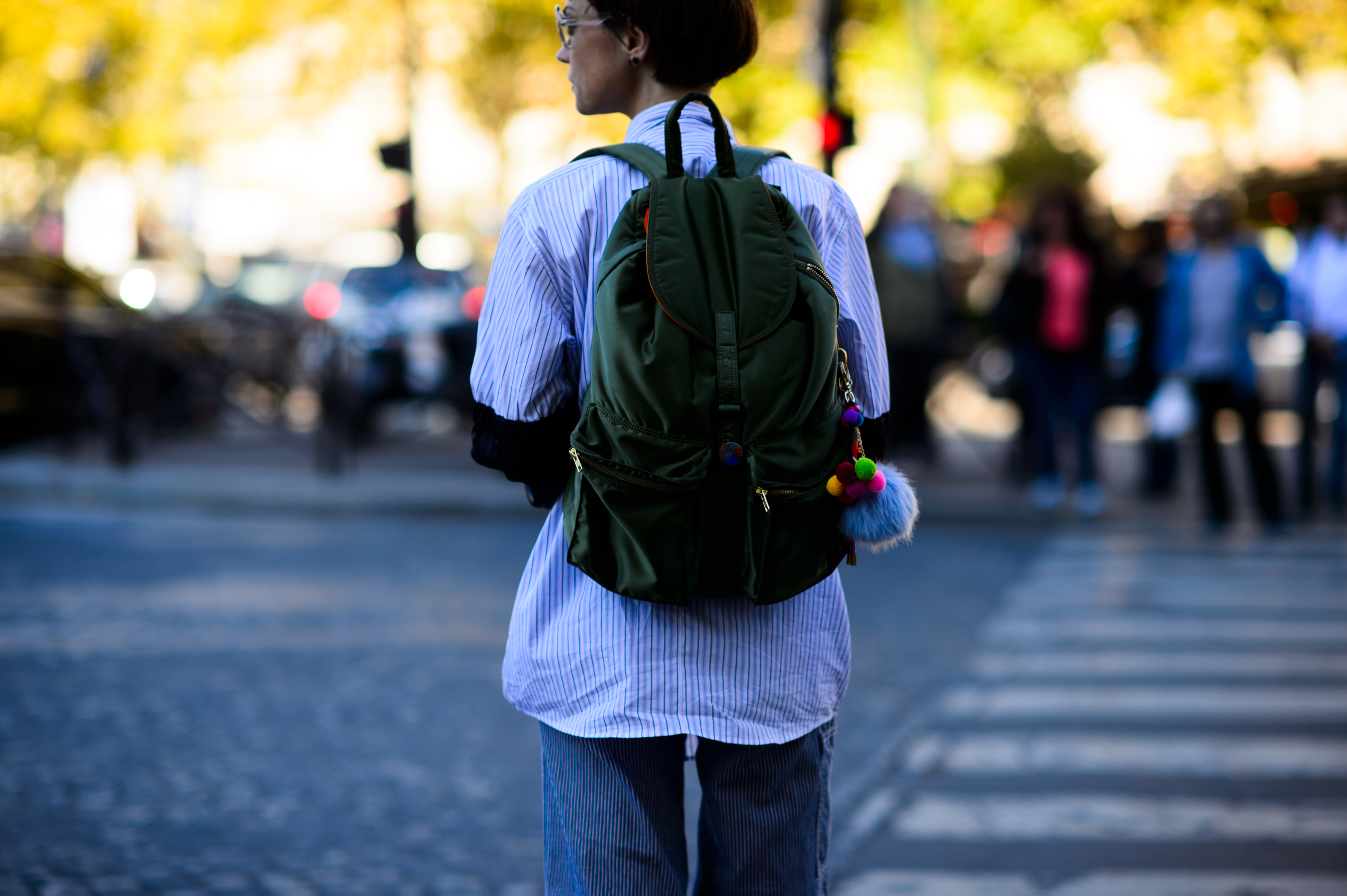 Woman in striped shirt and green backpack