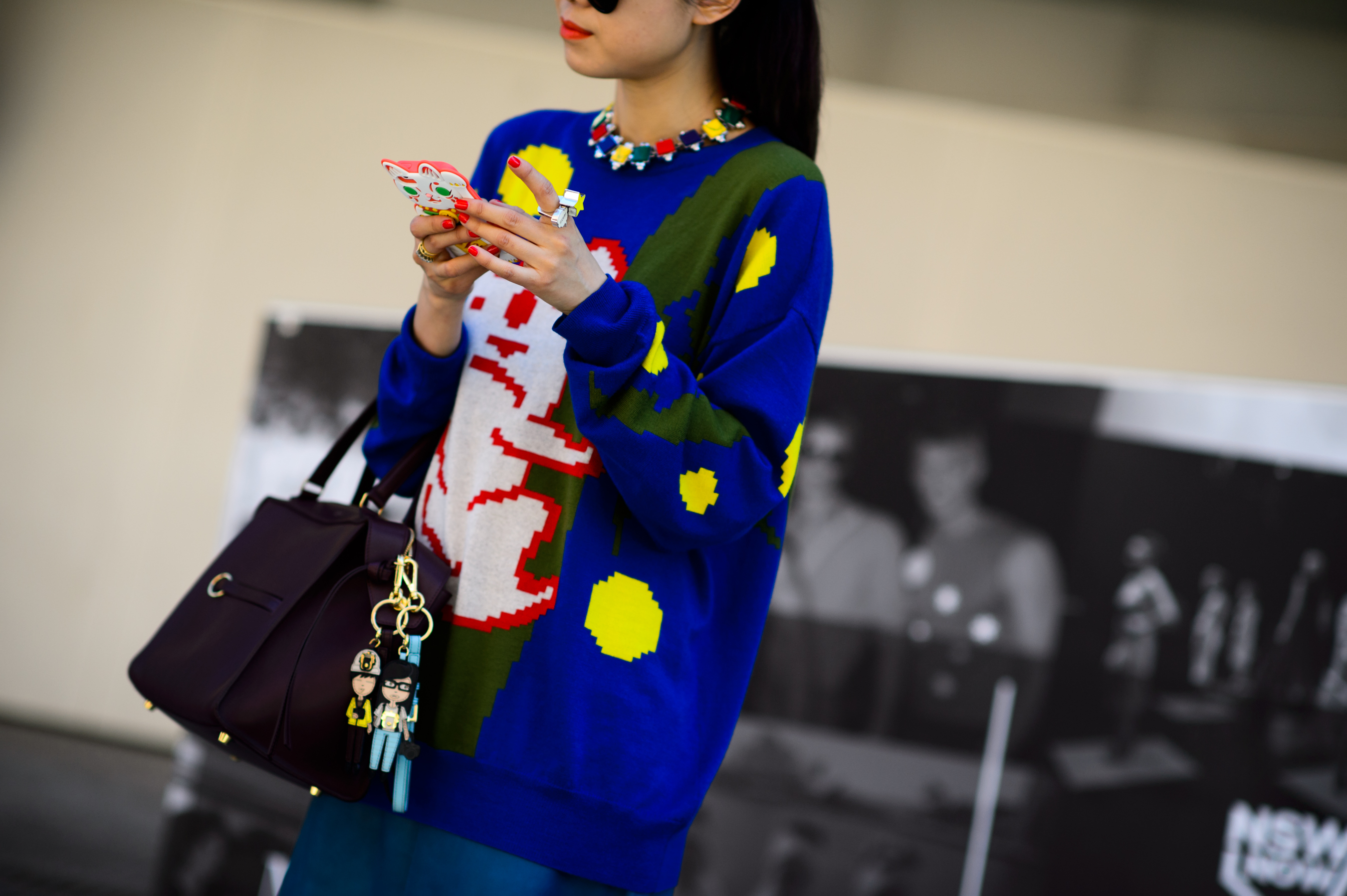 Woman wearing blue sweater with pixelated print