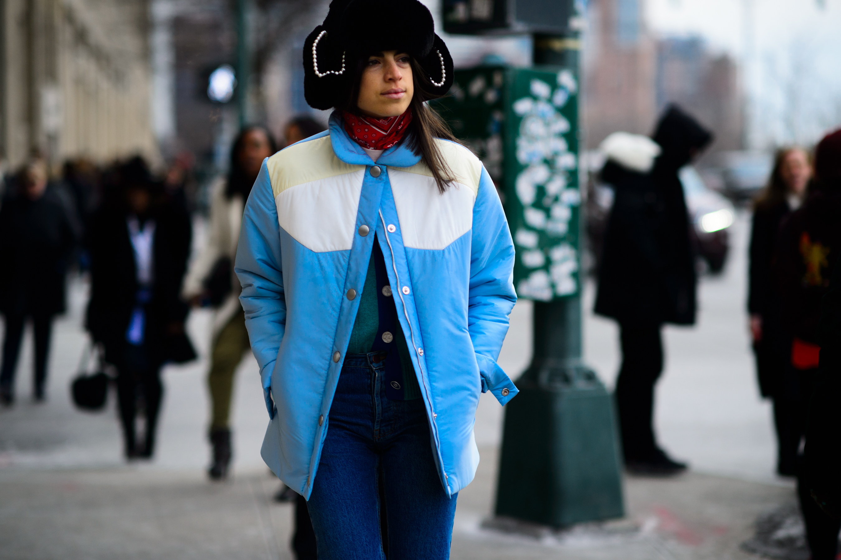 American blogger wearing blue jacket and big hat