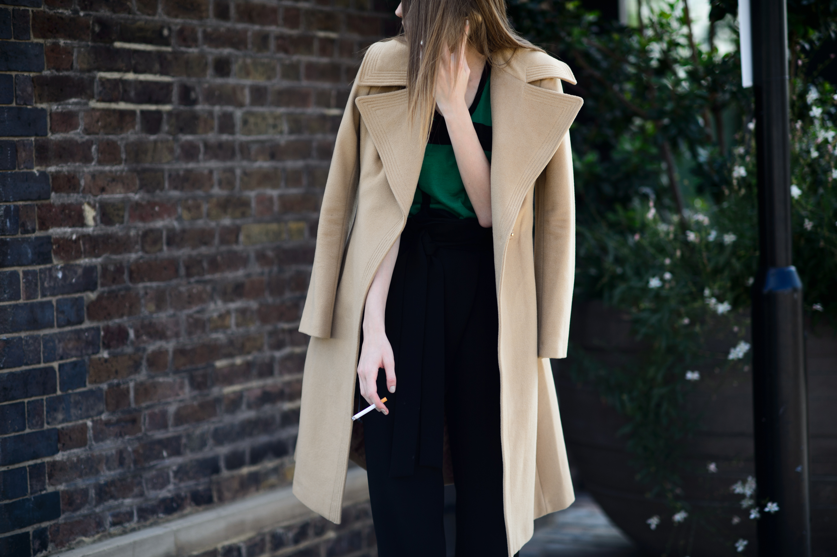 Model wearing beige coat after the show
