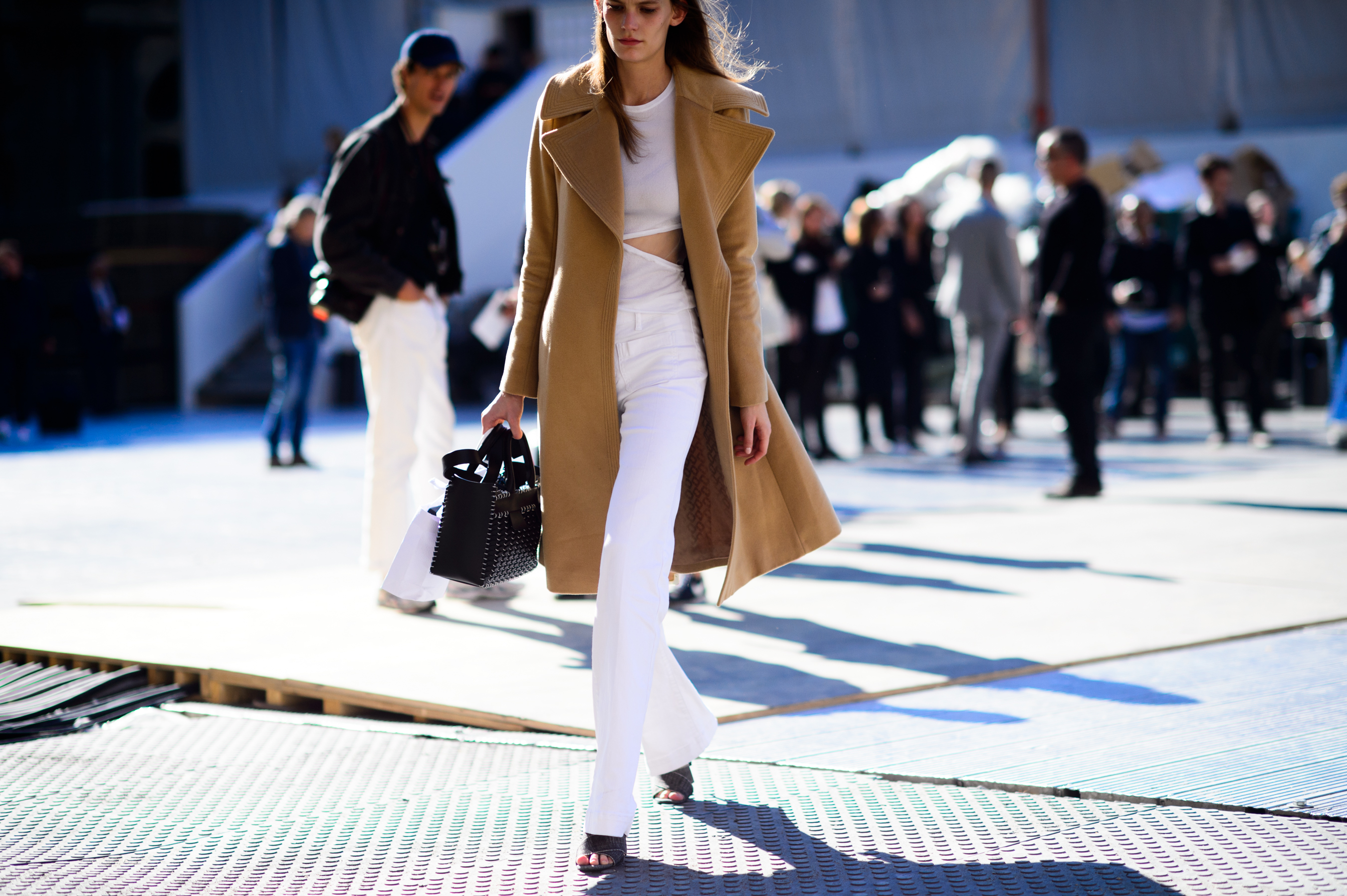 Model wearing camel coat after the show