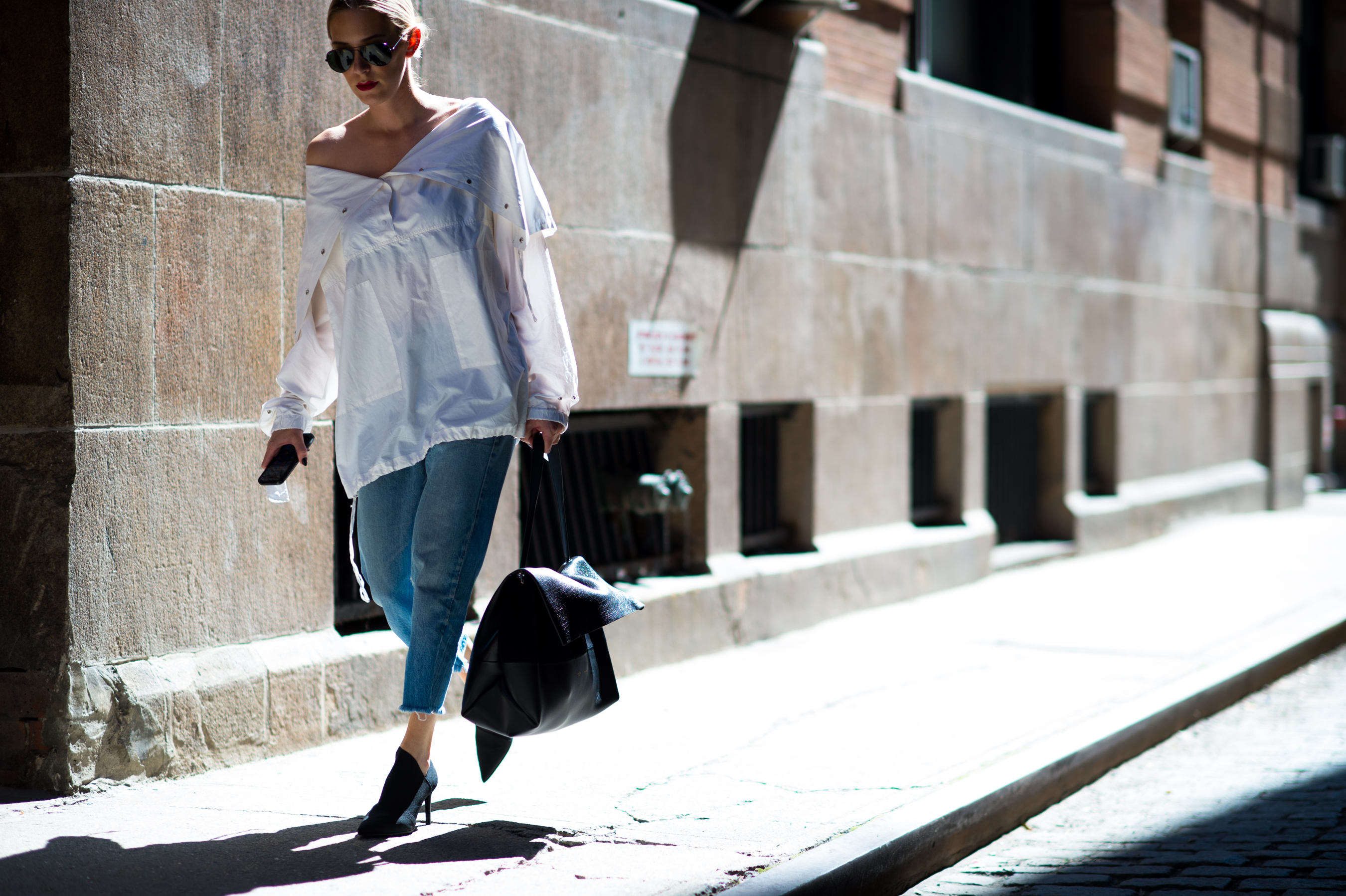 Woman wearing oversized white shirt and jeans