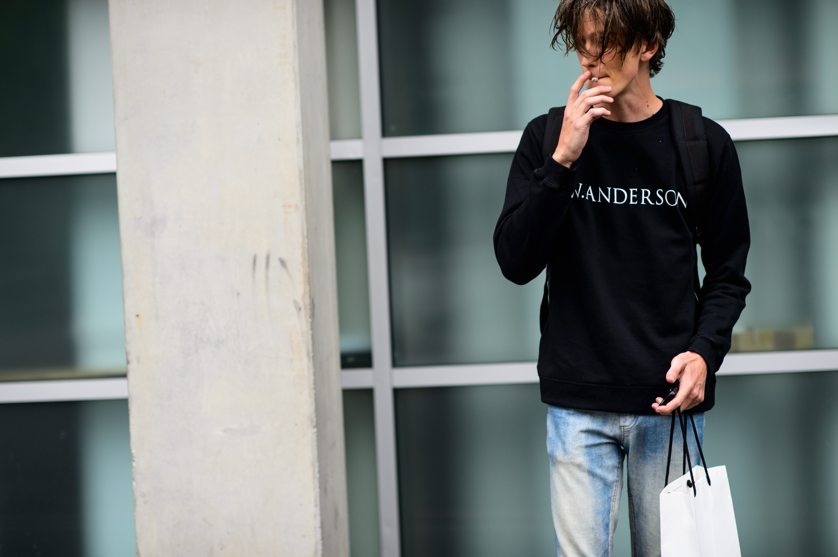 British male model wearing sweatshirt with designer's name