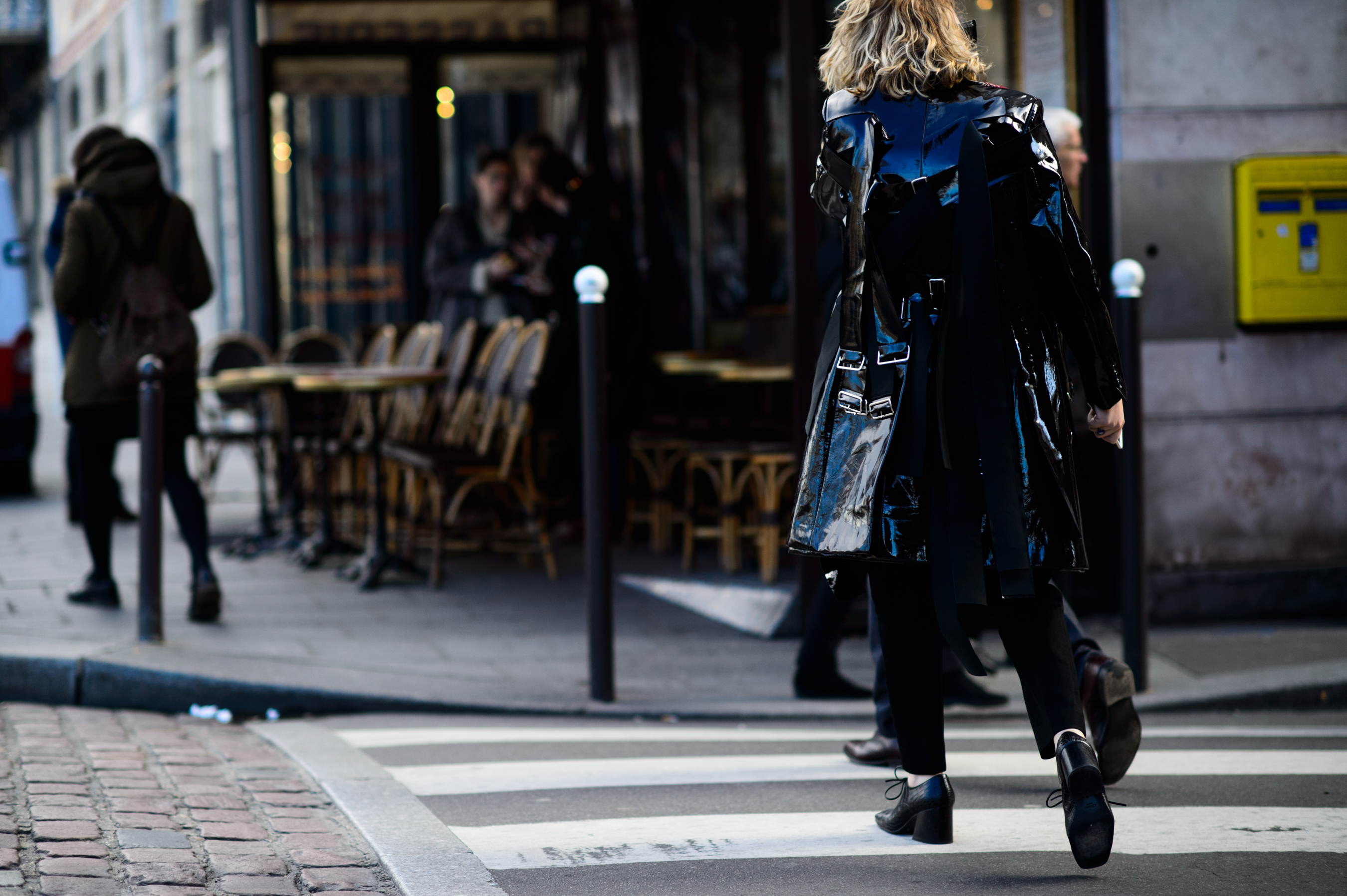 Woman wearing shiny leather coat